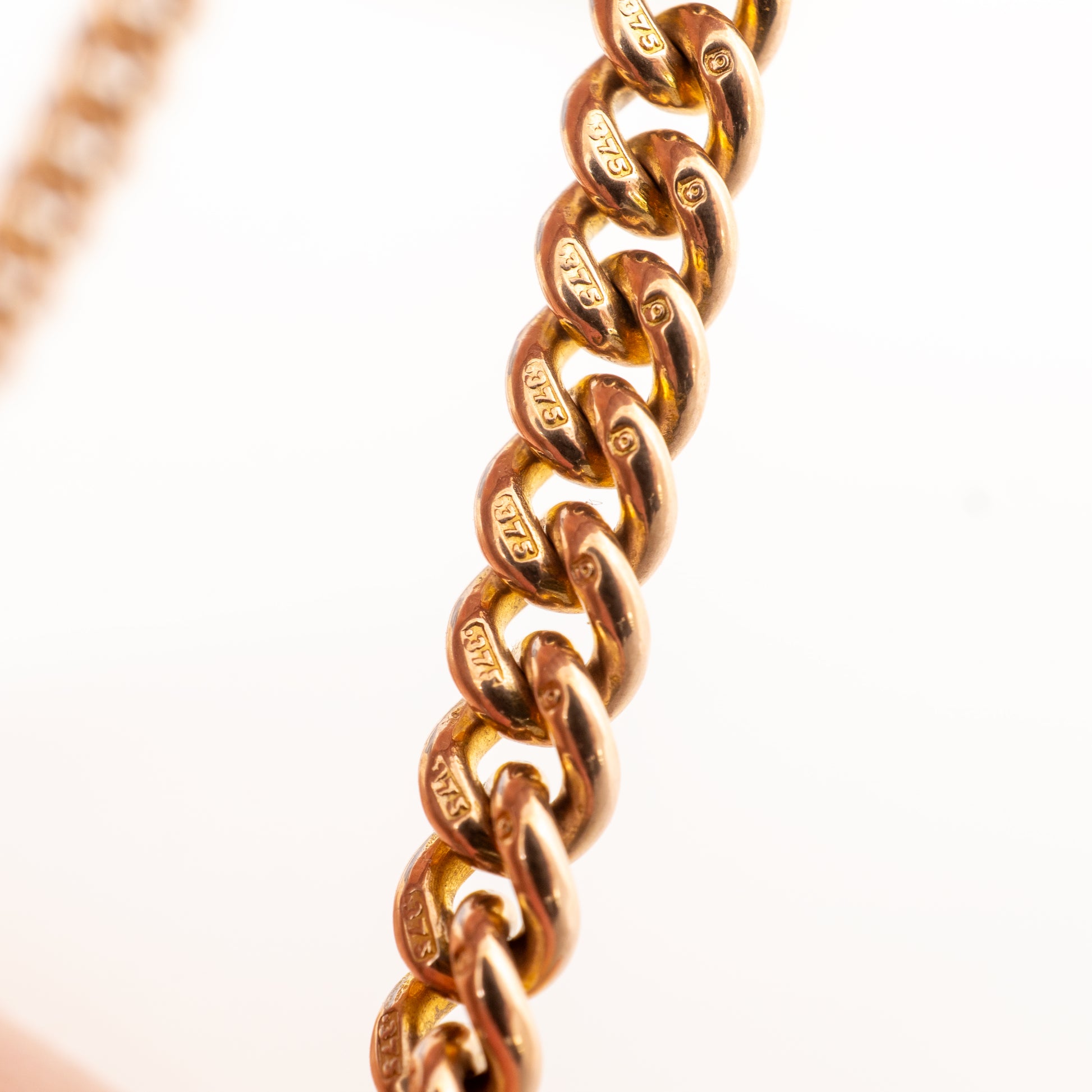 Close-up of individually hallmarked 375 curb links on an antique 9ct rose gold Double Albert watch chain