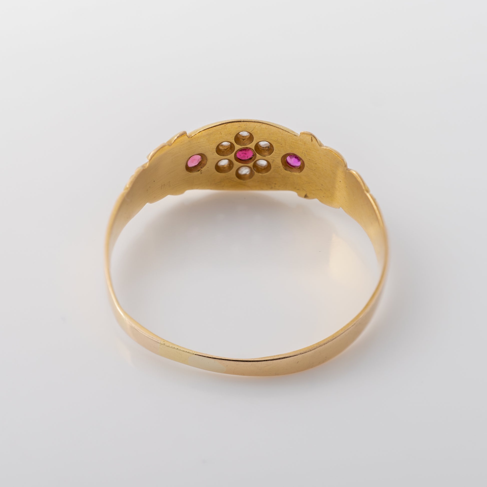 Antique gold gypsy ring with rubies and old-cut diamonds showing the back of the ring