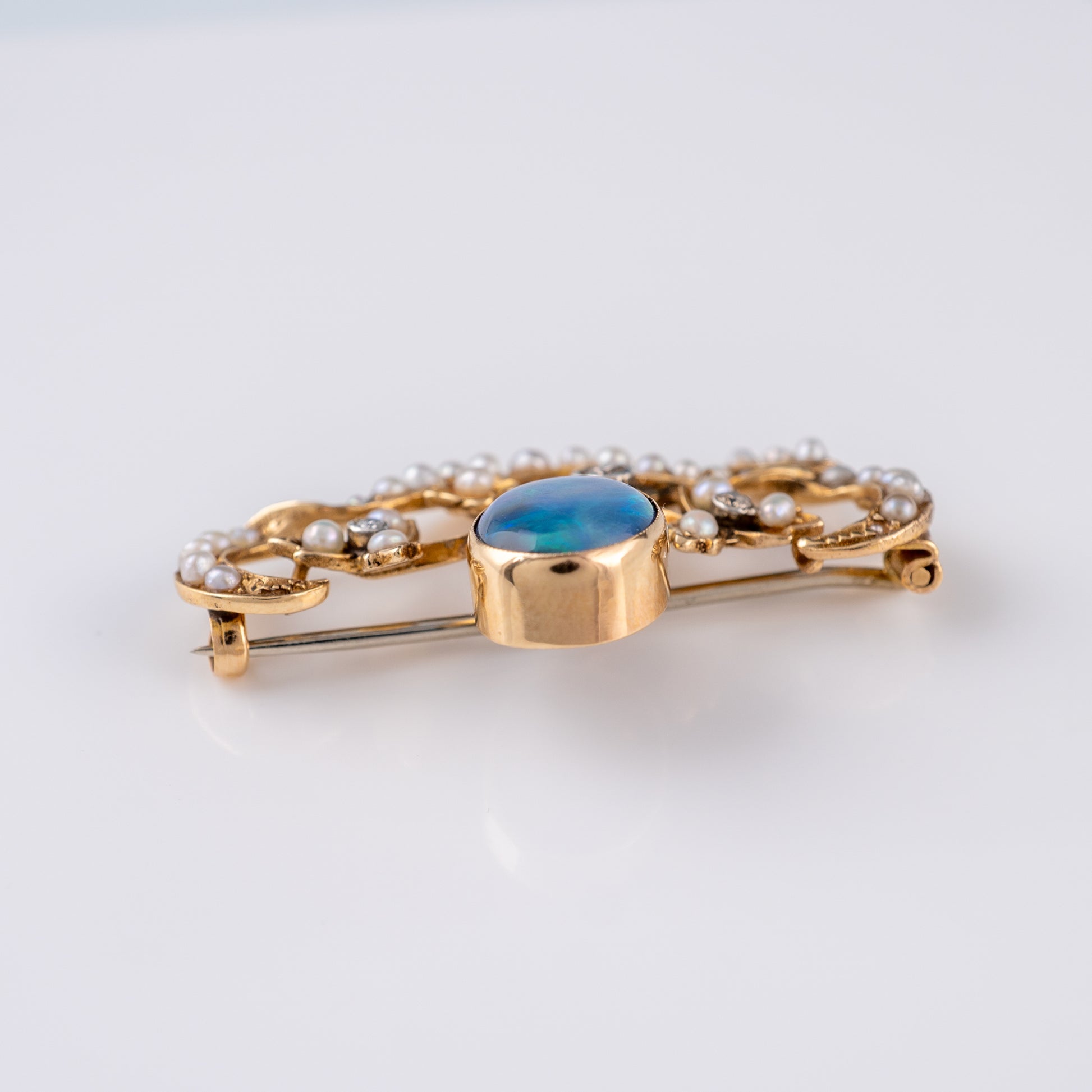 Top view of Art Nouveau opal brooch with pearl detail