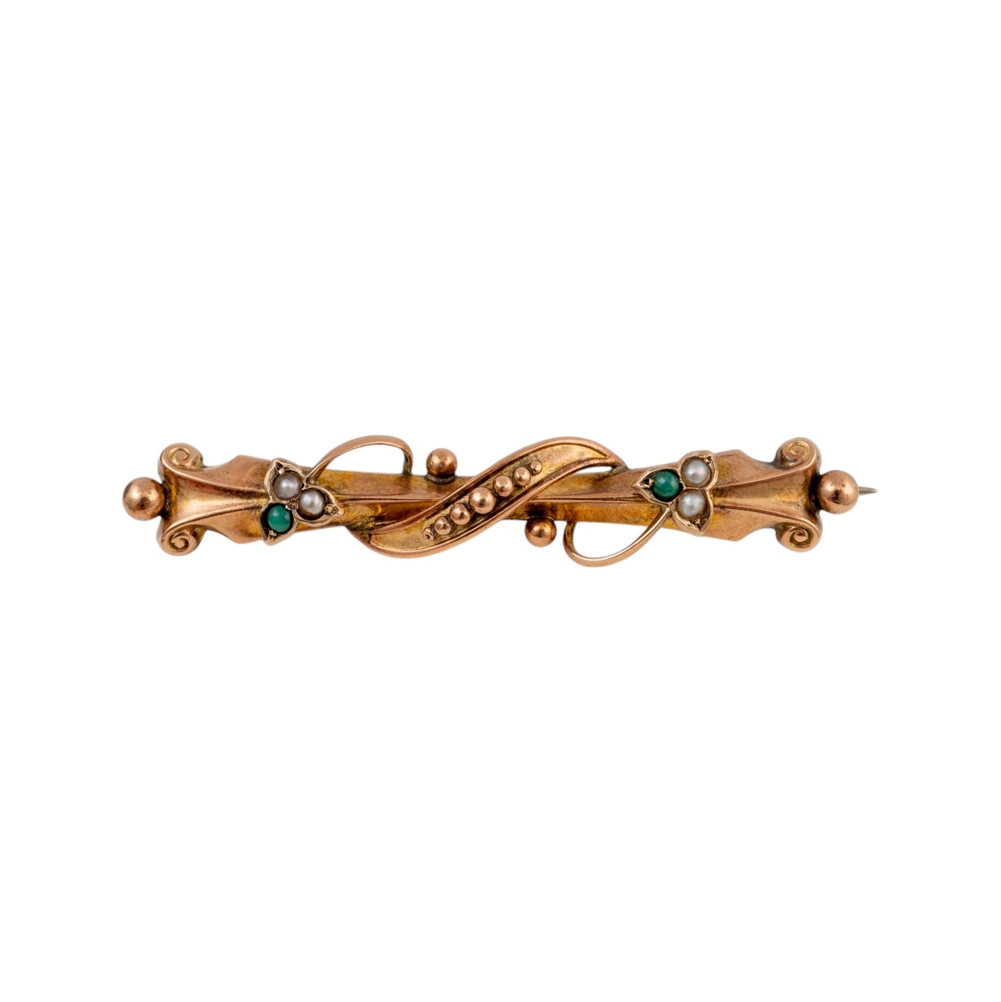 An ornate 19th-century gold brooch featuring a central twisted loop embellished with small green emeralds and white pearl-like accents, flanked by decorative scrollwork and bead details.