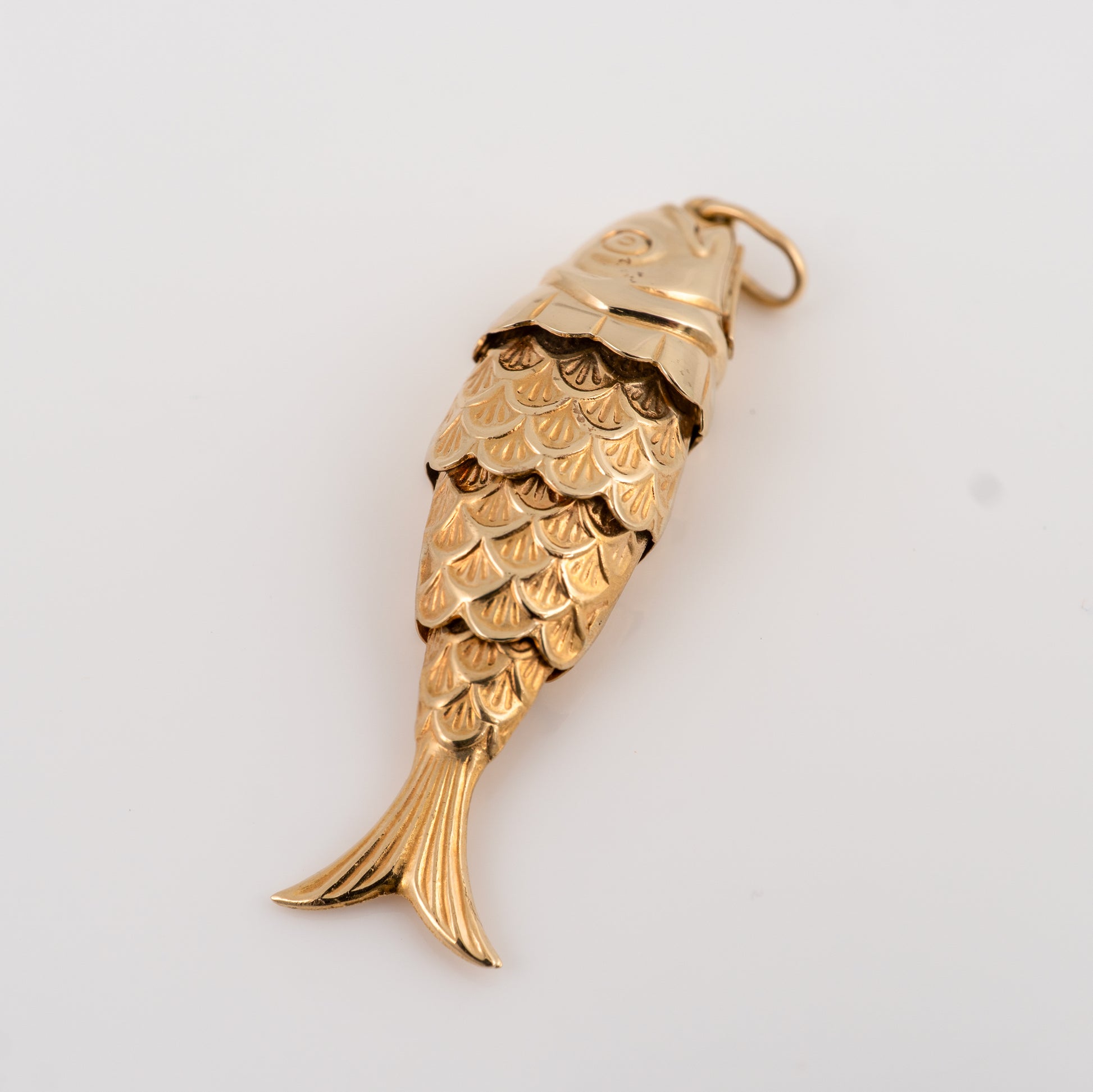 Articulated fish pendant showing joint movement