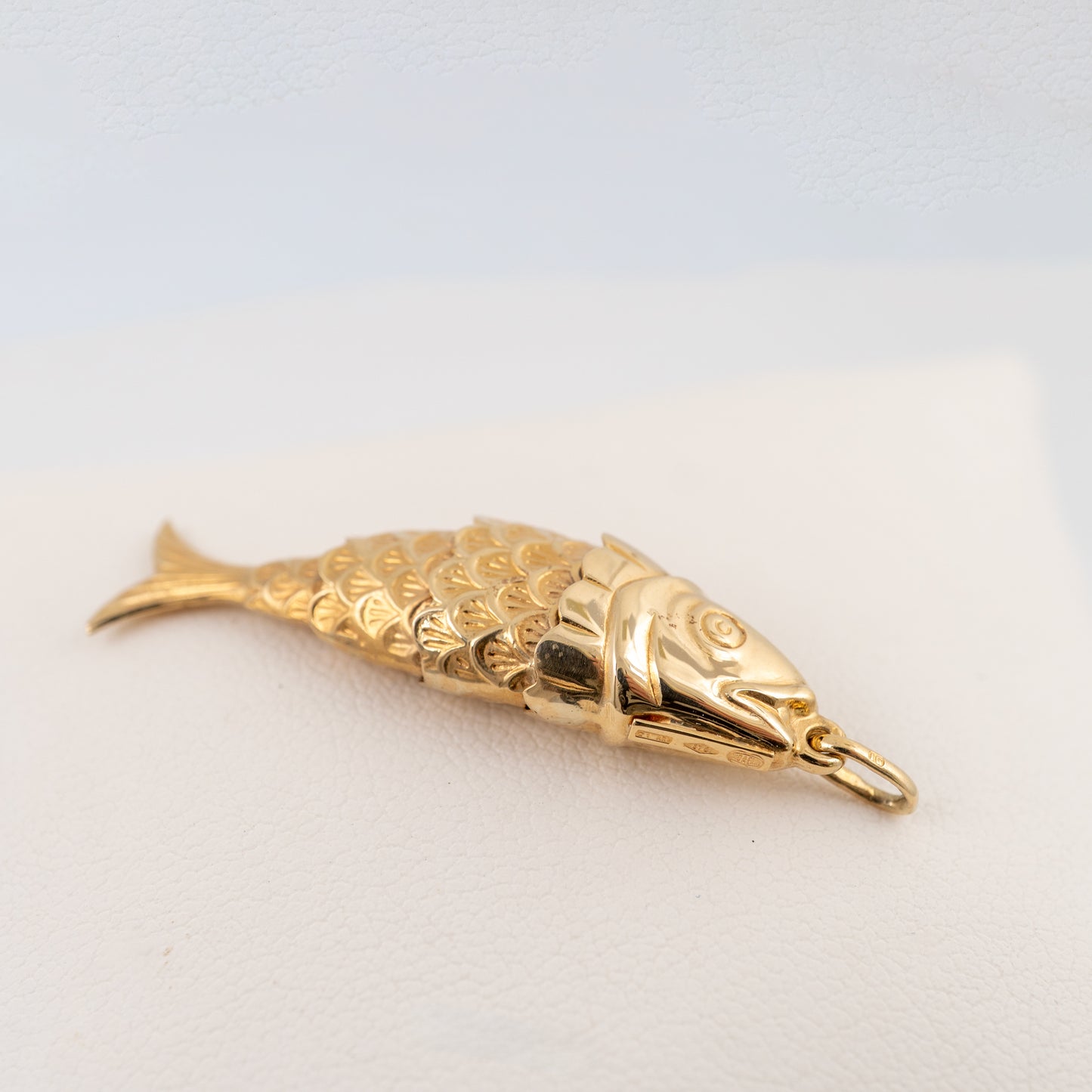 Side view of articulated 9ct gold fish pendant