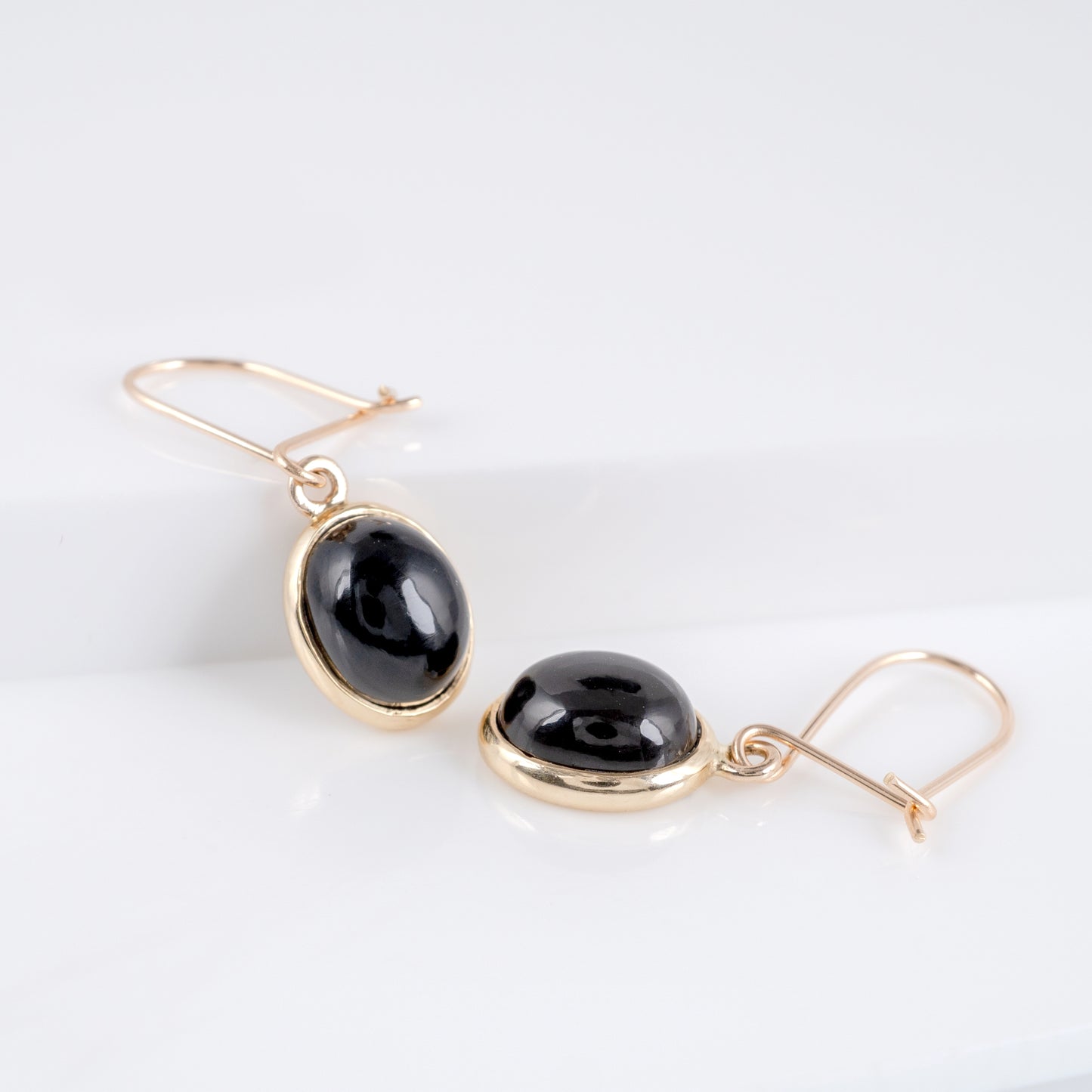 gold hook wire earrings with black gemstone