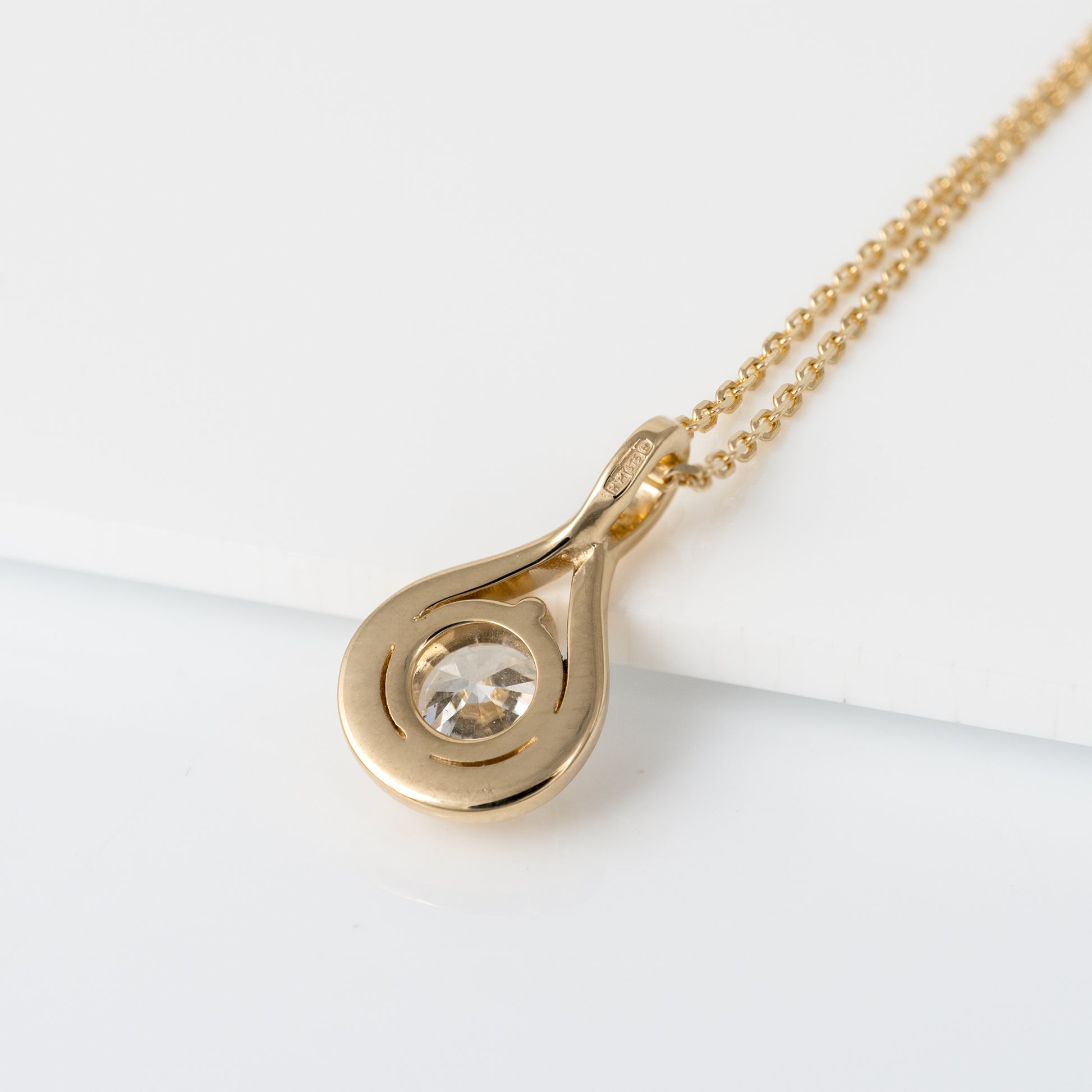 Back view of lab grown diamond infinity necklace in yellow gold hallmarks