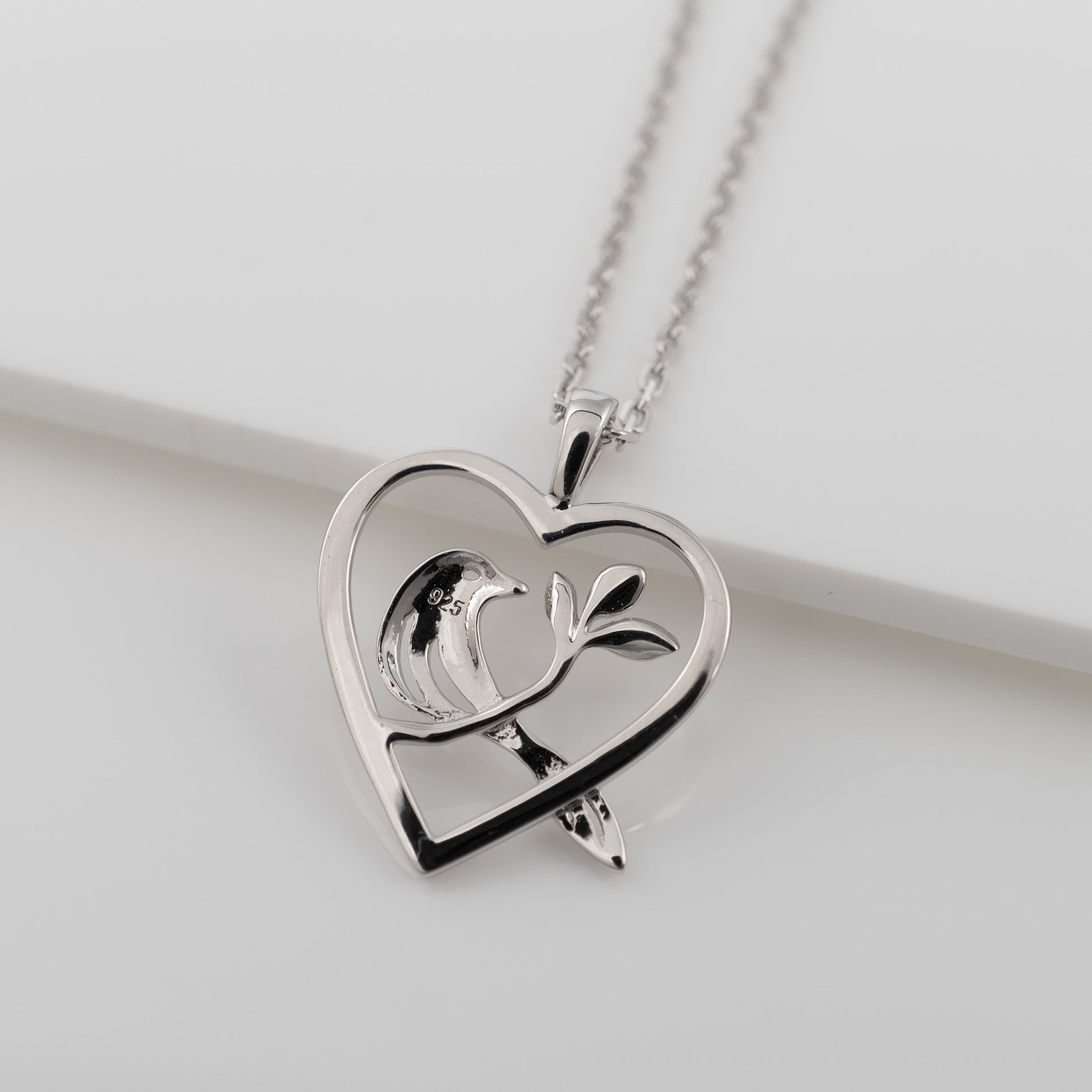 Back of the sterling silver bird heart pendant showing 925 stamp