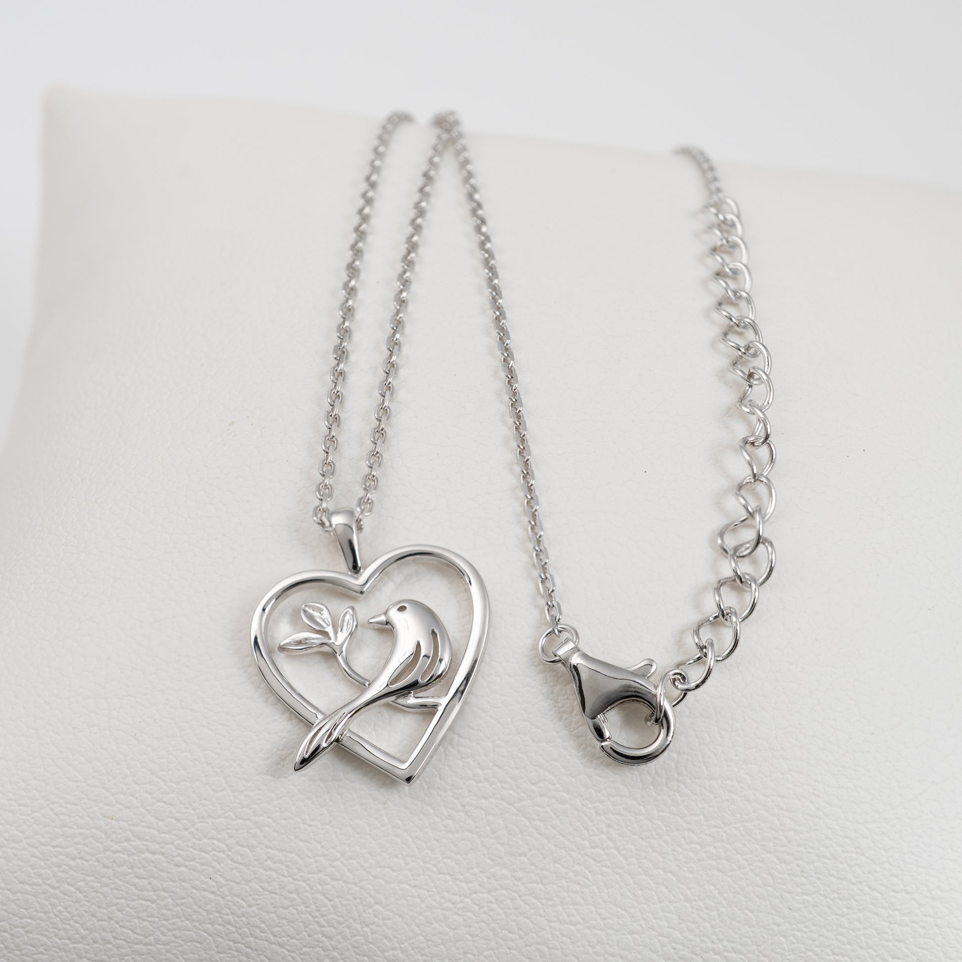Sterling silver bird heart necklace shown with adjustable chain