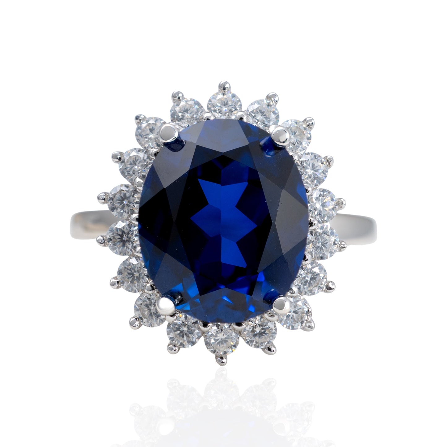 Ring with a blue gemstone and diamond-studded halo on a white background