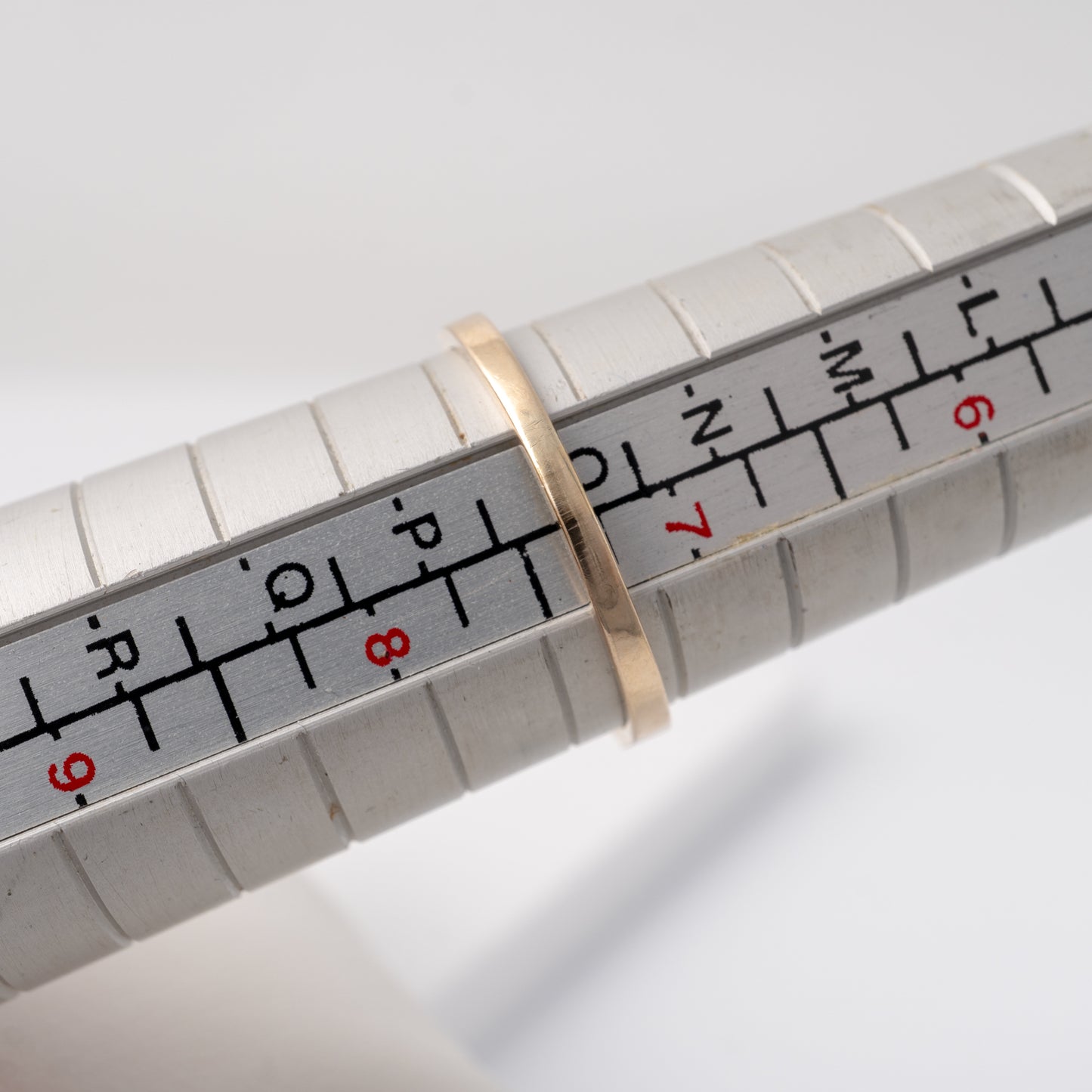 Vintage citrine ring placed on a ring resizer stick, showing its UK size O or US 7 1/3 measurement