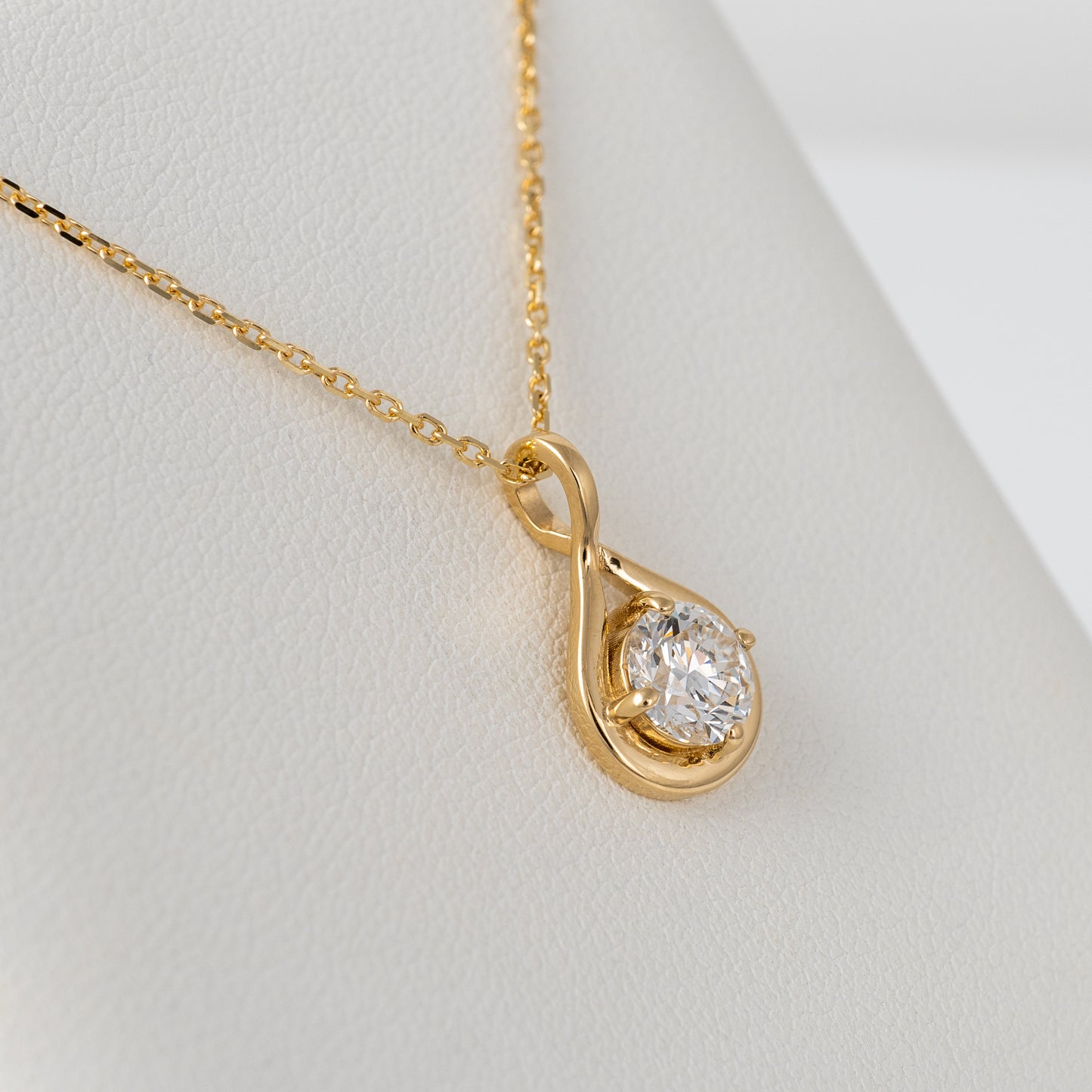 Close-up of infinity necklace with lab grown diamond, 9ct yellow gold