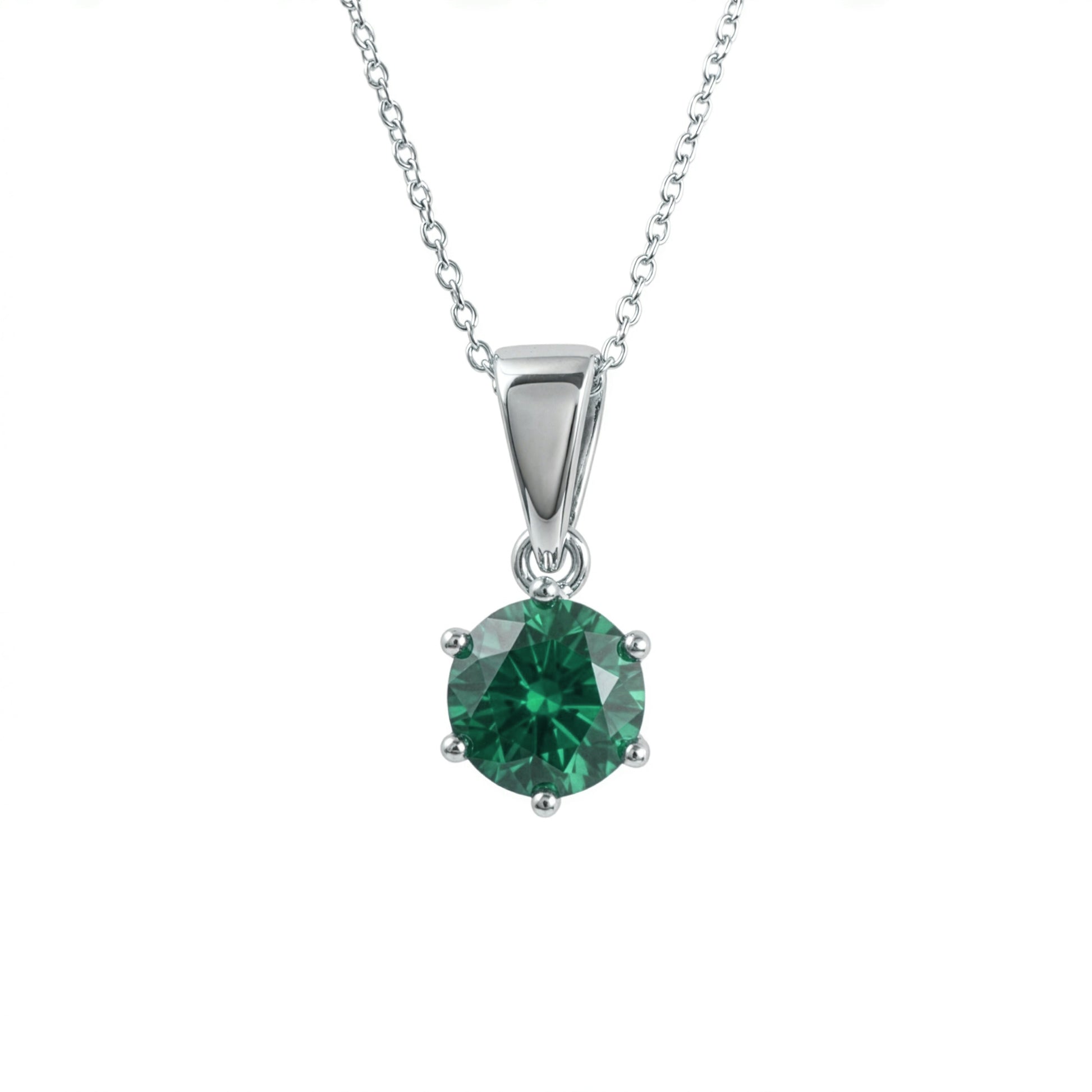 A silver pendant lab grown emerald necklace in a four-prong setting, suspended from a delicate silver chain against a plain white background.
