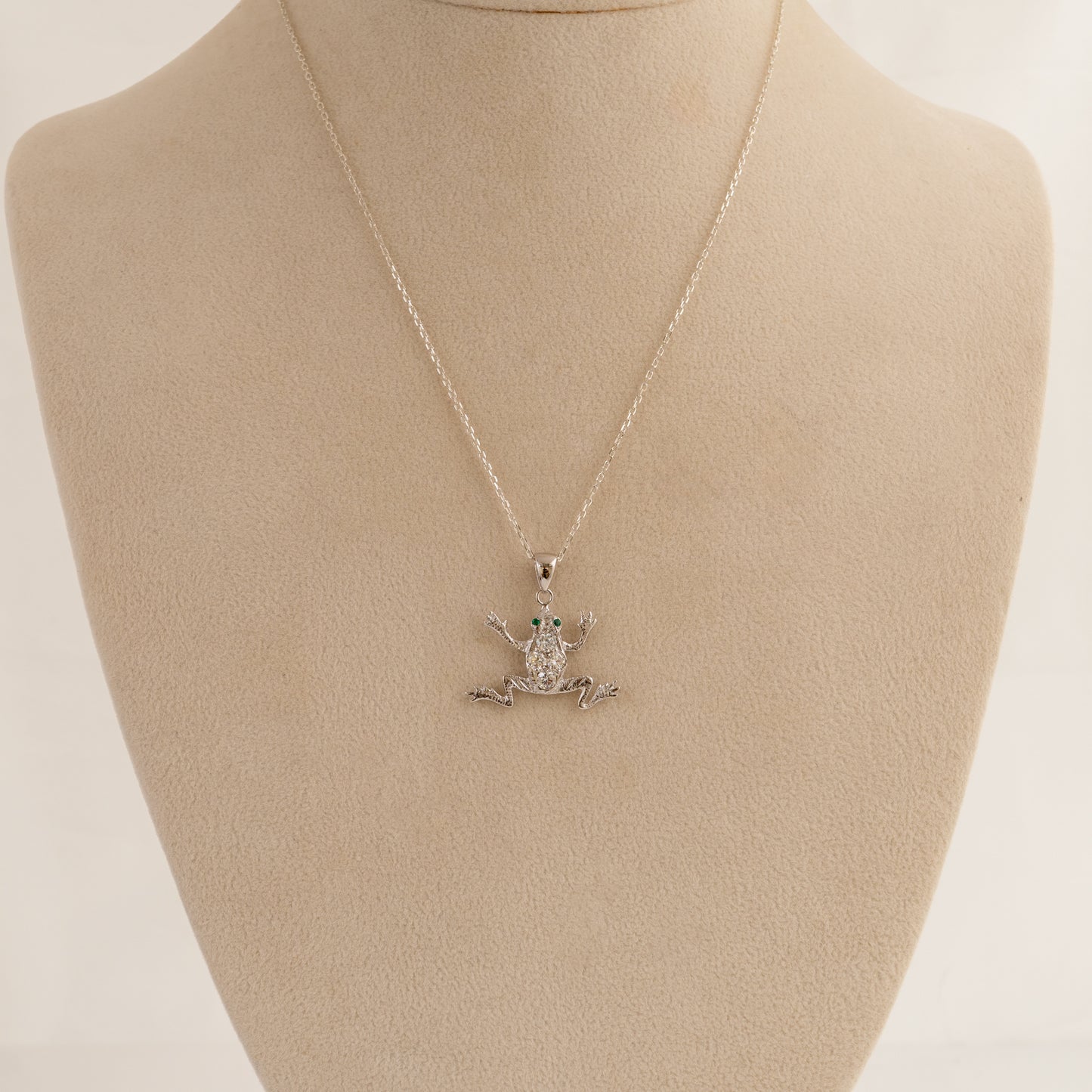 diamond frog pendant  with a pendant on a beige mannequin bust