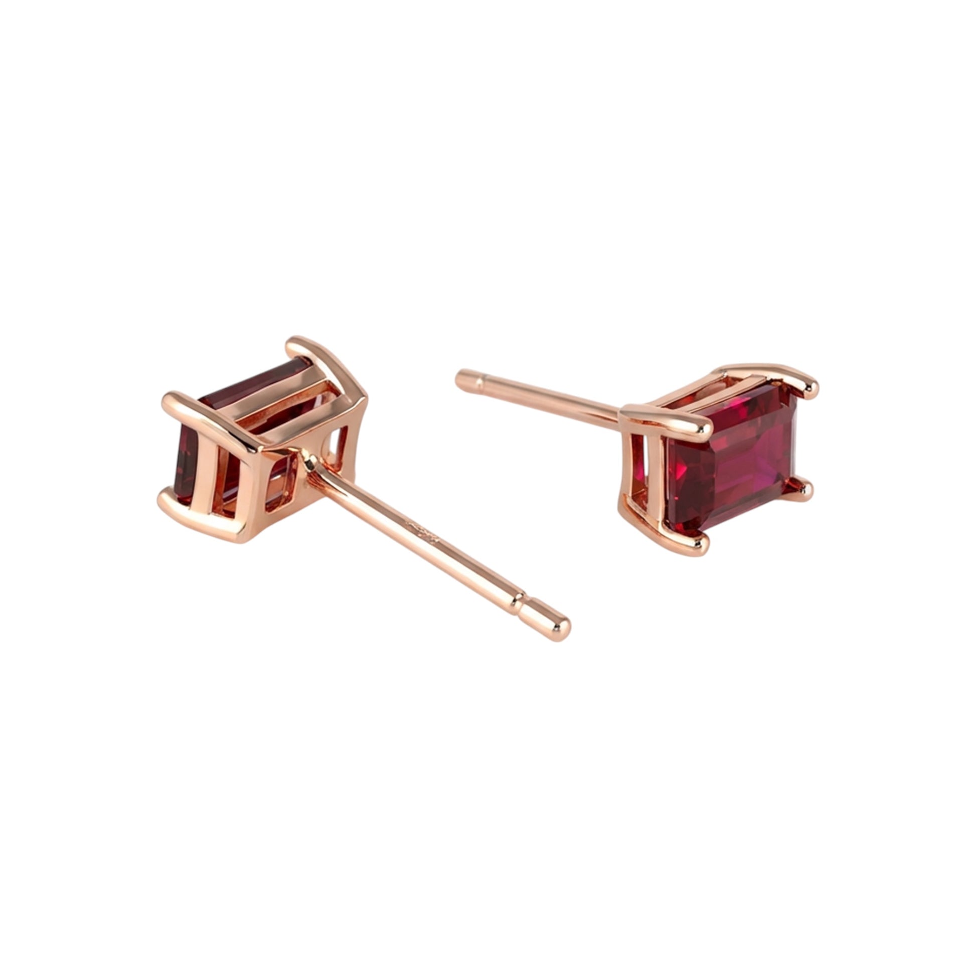 Rose gold earrings with lab grown rubies on a white background