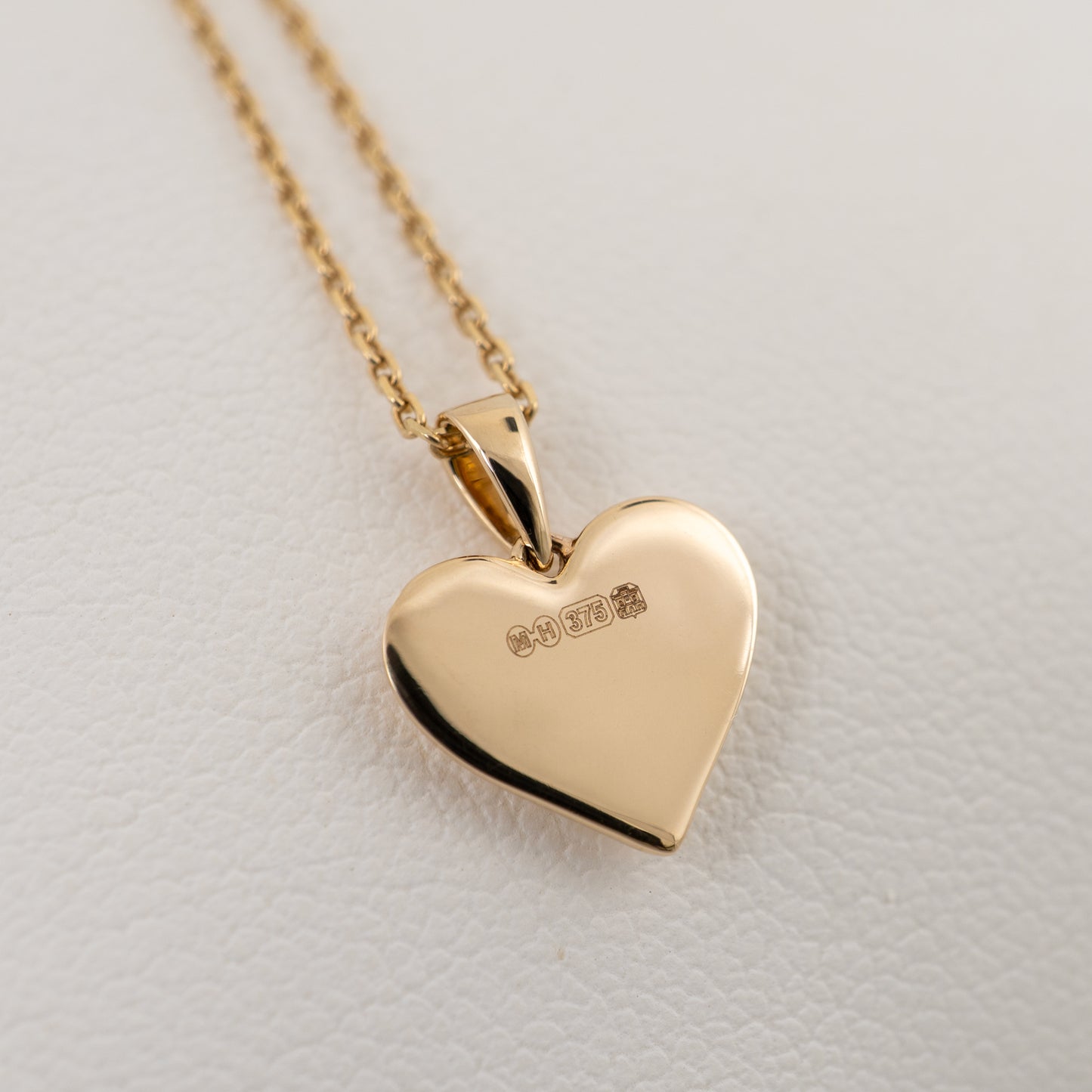  Back of 9ct gold heart pendant stamped with UK hallmarks