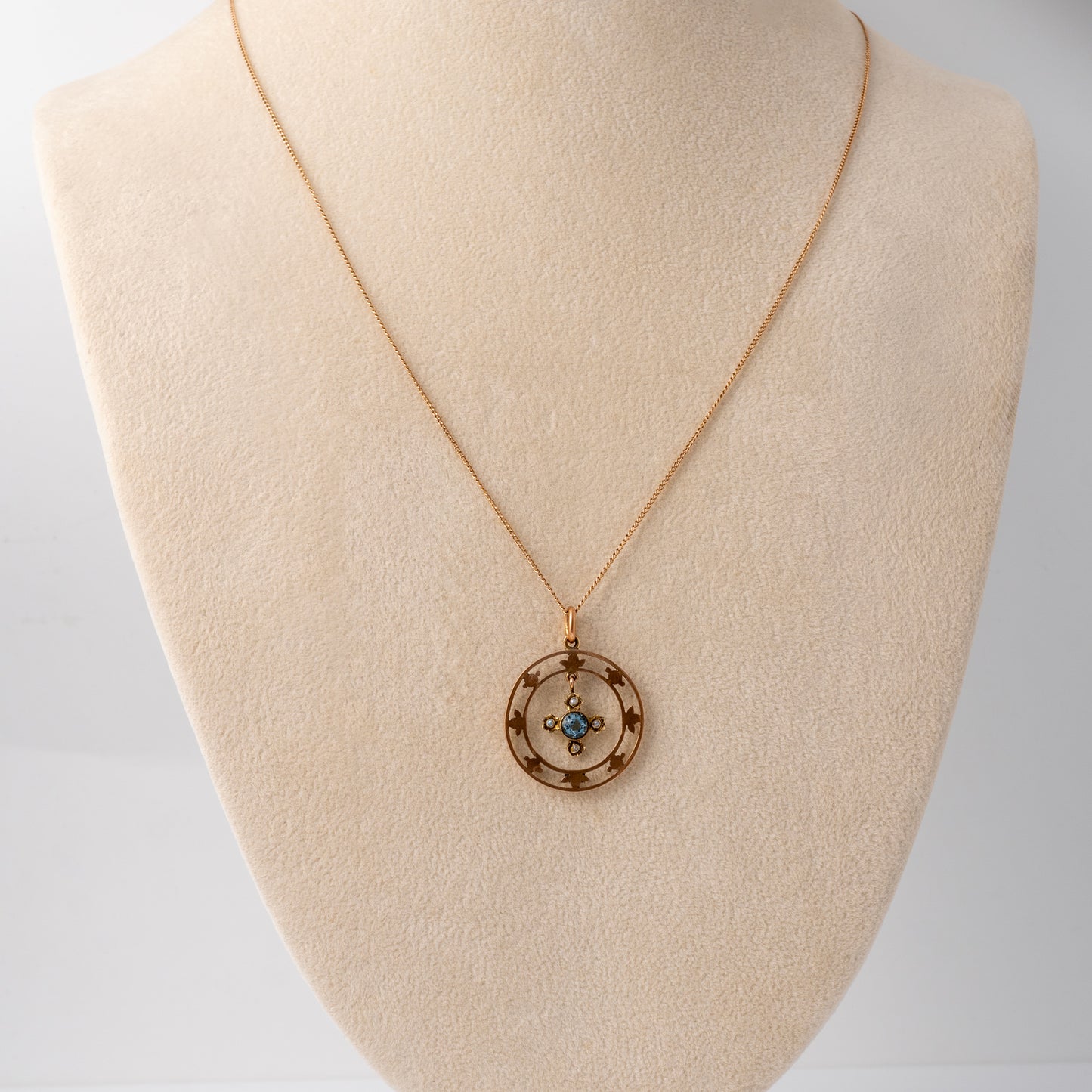 Antique aquamarine necklace with floral 9ct gold pendant displayed on a bust by Hunters Fine Jewellery