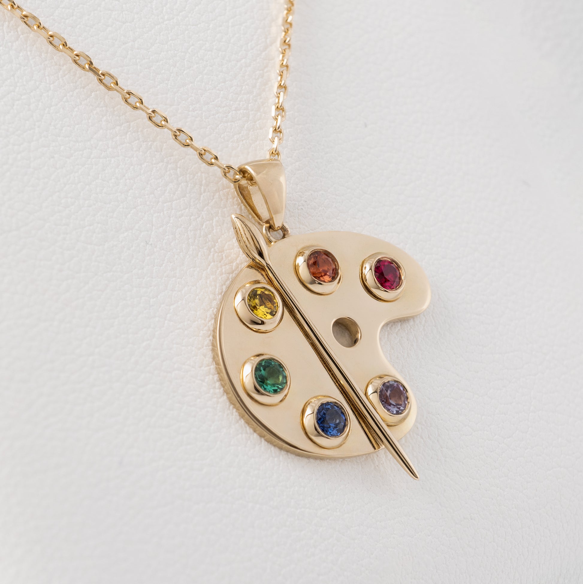 close up Yellow gold necklace for artists with gemstone colours representing paint