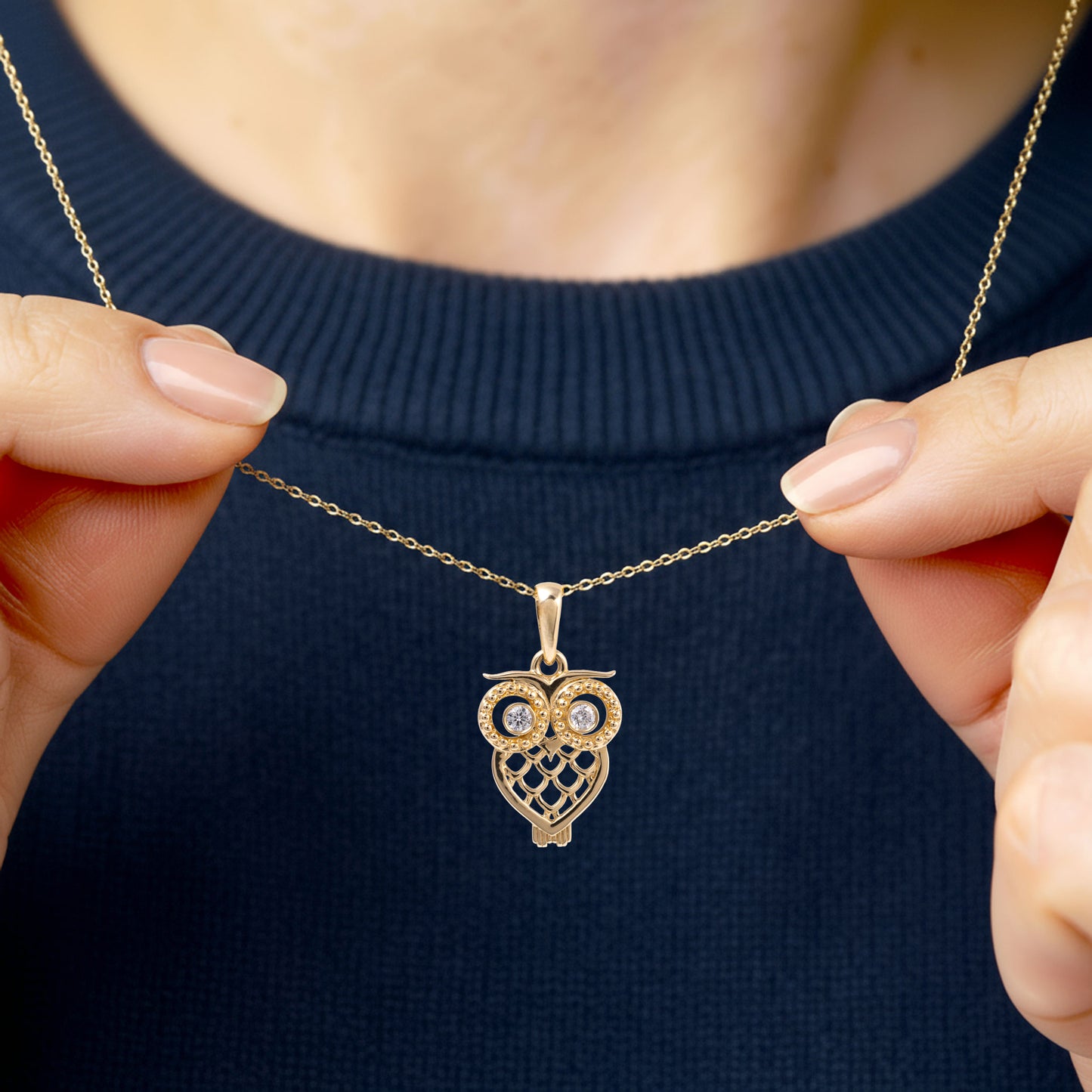 woman wearing a gold owl pendant 