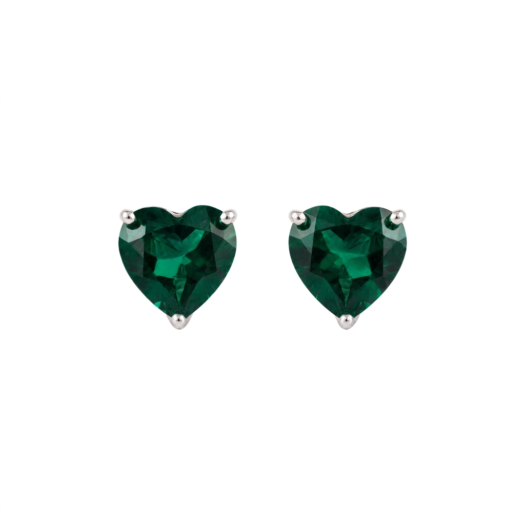 Heart shaped lab grown emerald earrings in sterling silver, front view of the pair showing the deep green stones and three-claw settings