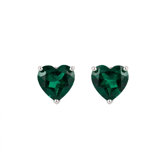 Heart shaped lab grown emerald earrings in sterling silver, front view of the pair showing the deep green stones and three-claw settings