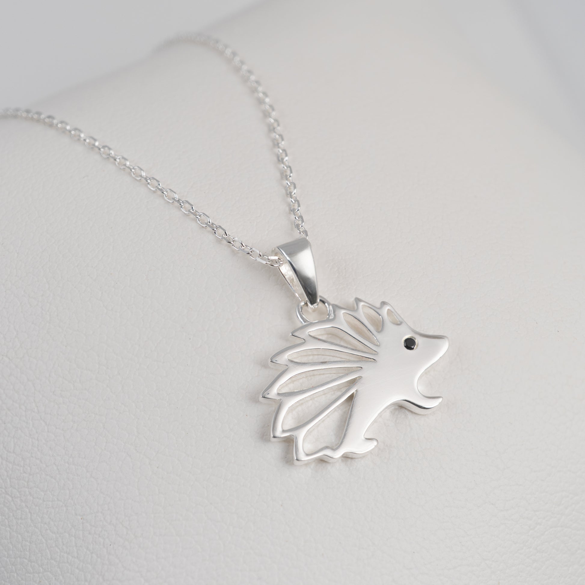 Sterling silver hedgehog necklace side view – polished finish with gemstone eye