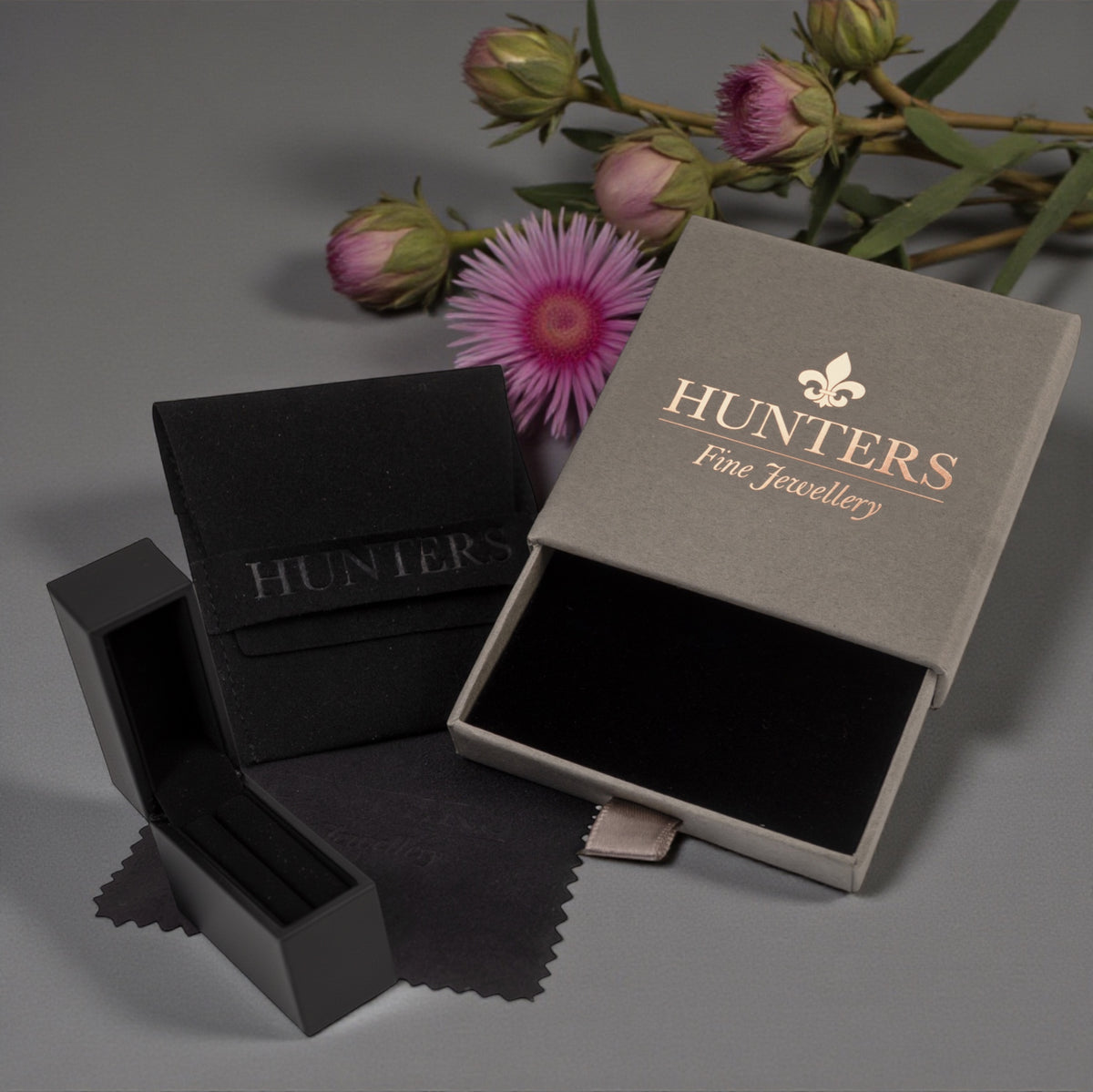 Hunters Fine Jewellery boxes, one open and one closed, with pink flowers