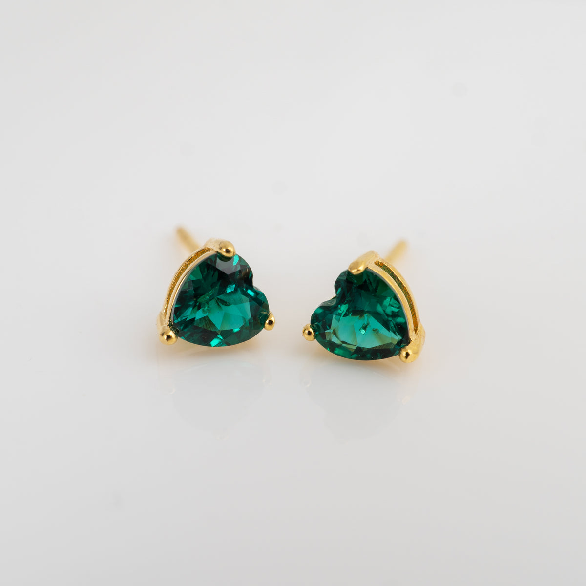 Emerald heart earrings in yellow gold plated sterling silver, with 5mm heart-cut lab grown emeralds in three-claw settings