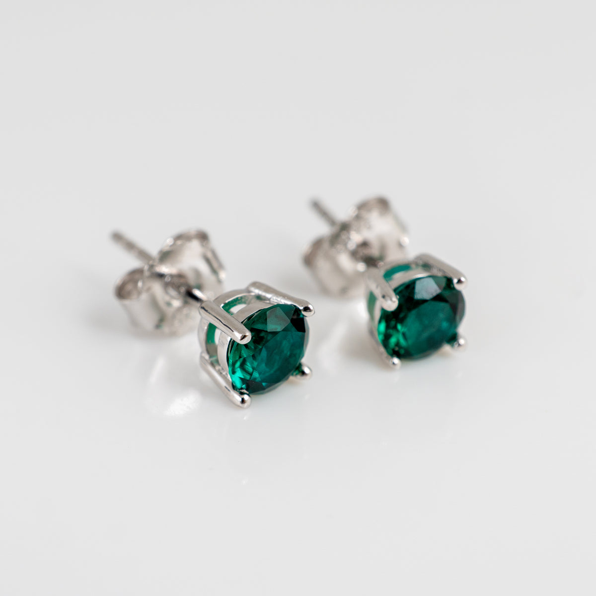 Lab emerald stud earrings with 5mm round deep green stones in sterling silver