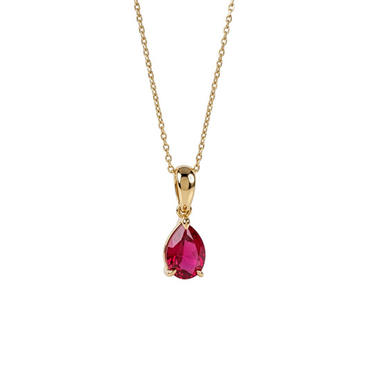 A gold pendant necklace featuring a teardrop-shaped lab ruby gemstone, suspended from a delicate gold chain against a plain white background.