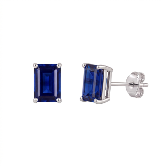 Lab sapphire earrings with royal blue rectangle step-cut sapphires in rhodium plated sterling silver, front and side view