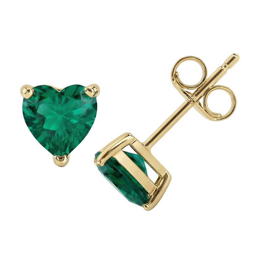 Gold earrings with heart-shaped green gemstones on a white background
