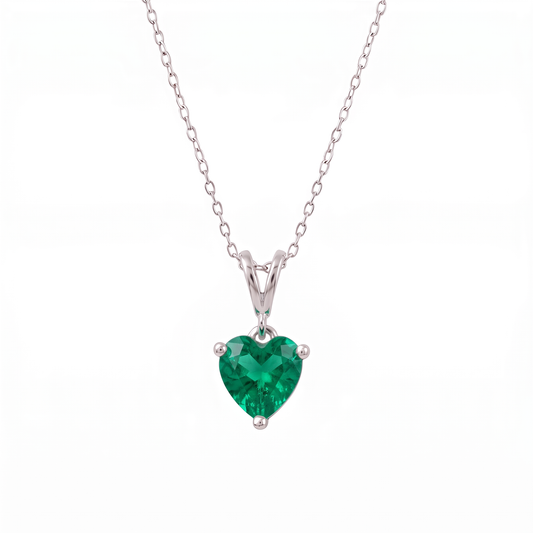 Heart-shaped emerald gemstone necklace on a white background