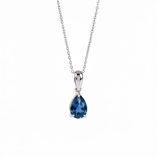 A silver pendant necklace featuring a teardrop-shaped london blue topaz gemstone in a polished silver setting, suspended from a delicate silver chain against a plain white background.