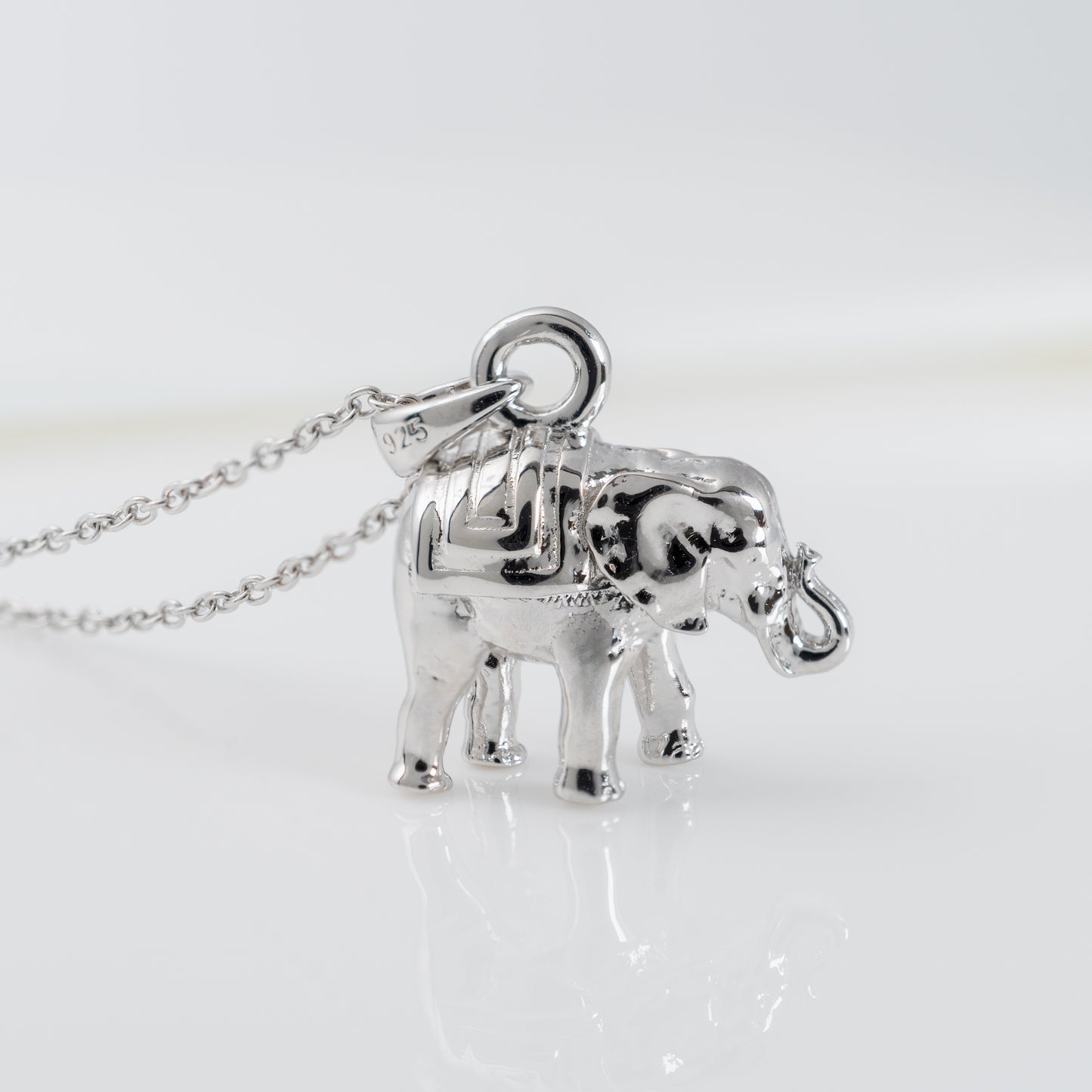 Close-up of lucky elephant necklace in sterling silver with raised trunk detail