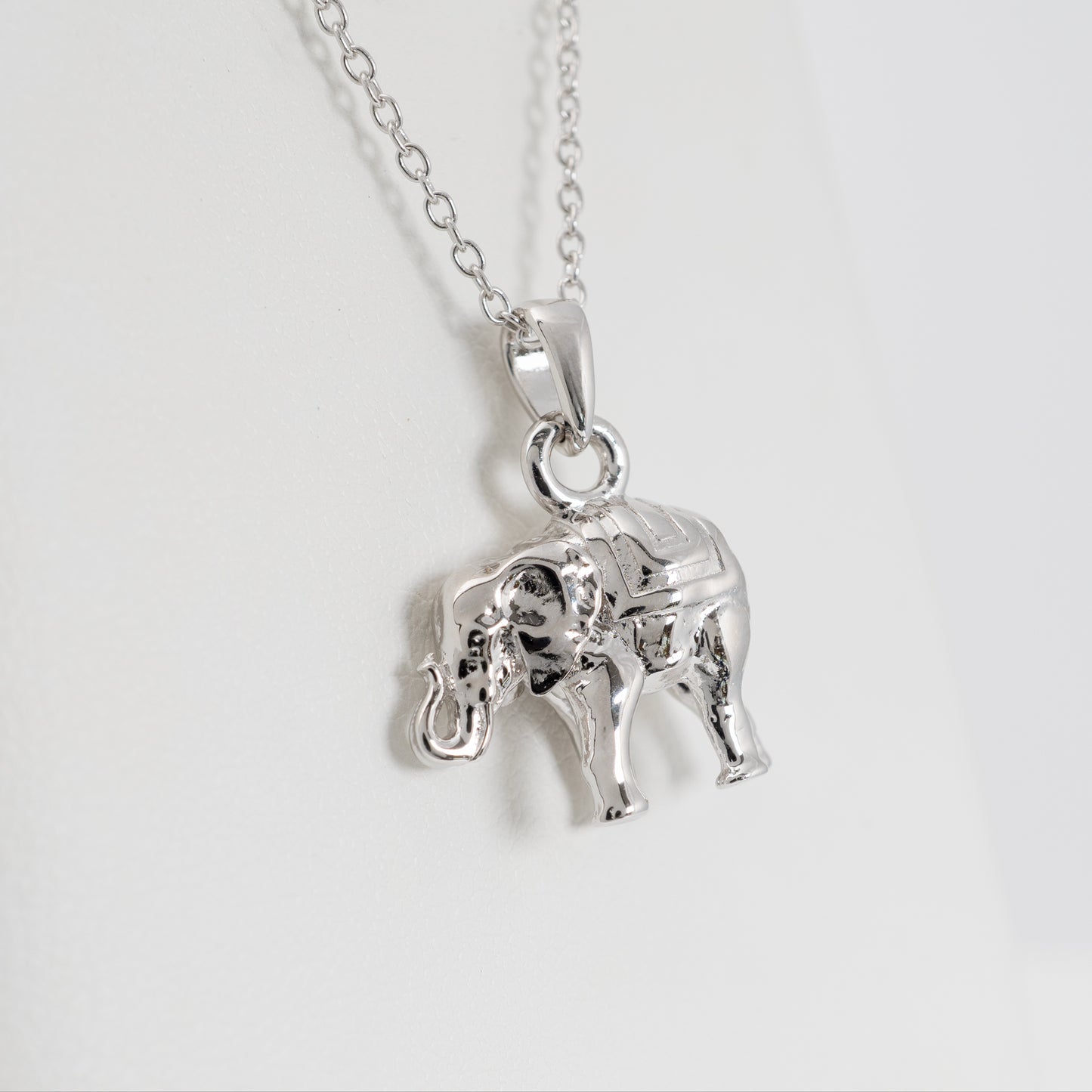 Close-up of lucky elephant necklace in sterling silver with raised trunk