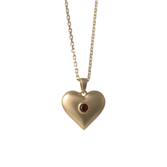 Front view of matte gold heart necklace pendant with garnet