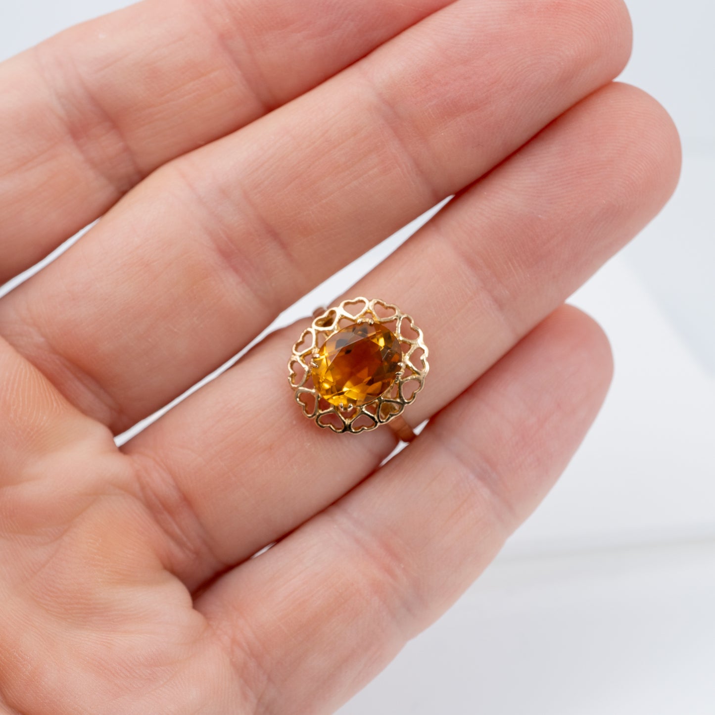 natural citrine ring on persons hand