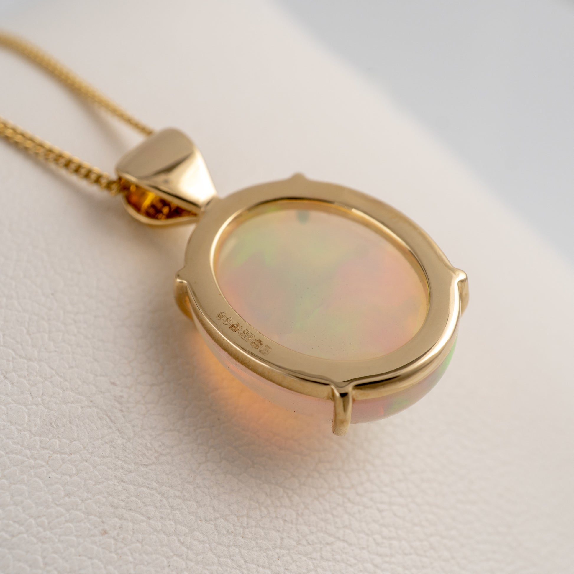 opal  pendant reverse side showing gold mount set with assay hallmarks