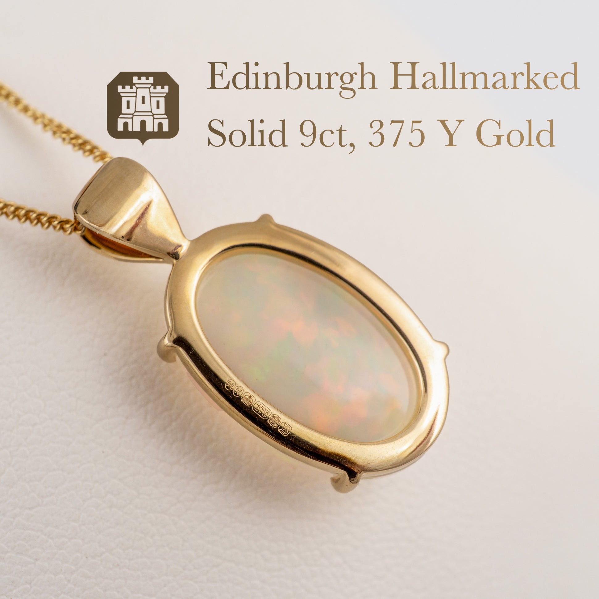 Gold pendant with opal stone on a light background, featuring Edinburgh Hallmarked text.