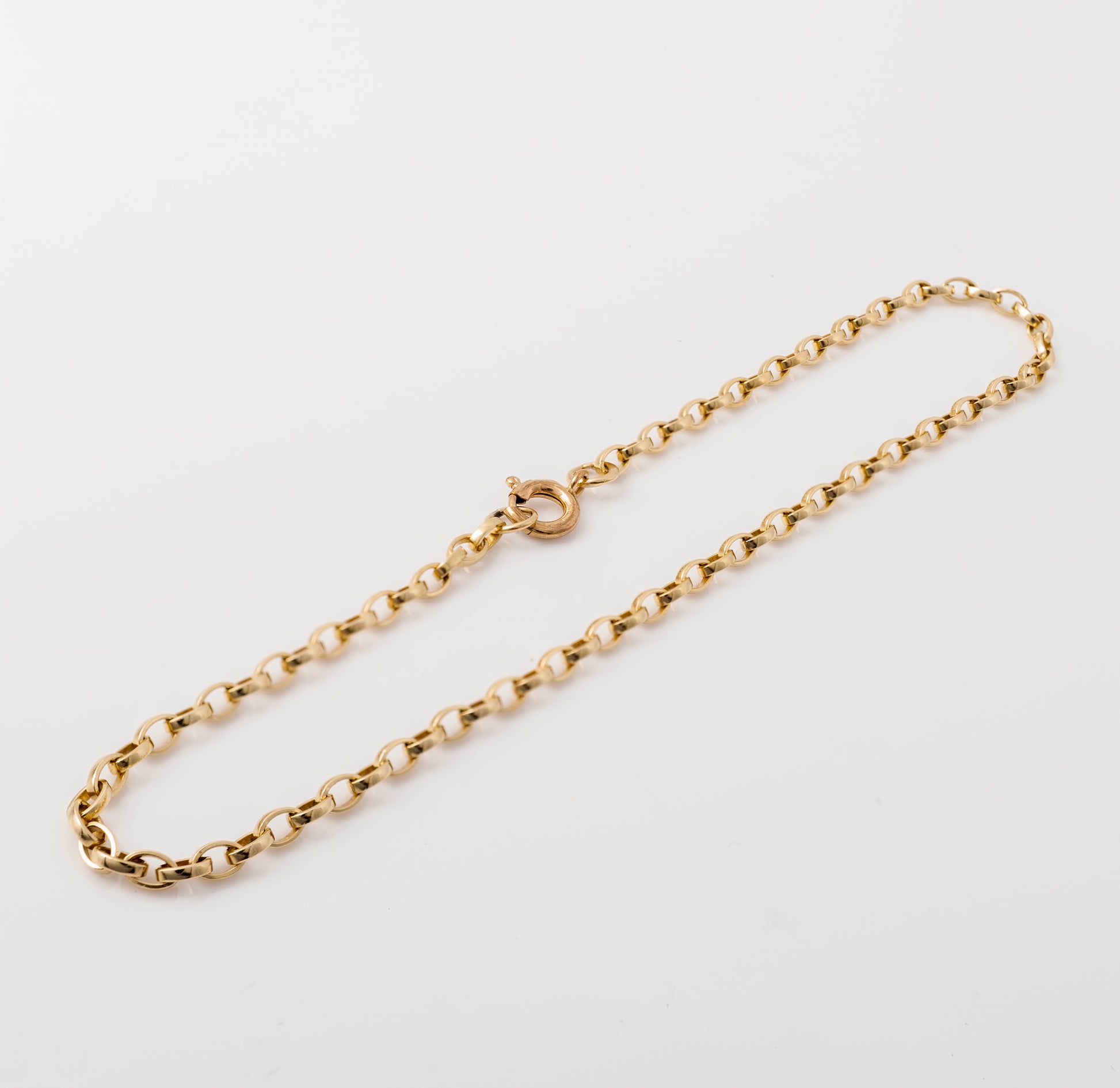 Gold belcher bracelet held to show link details