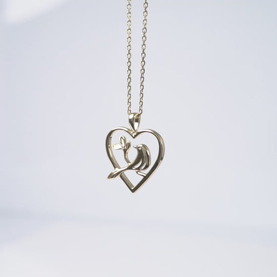 yellow gold bird in heart necklace