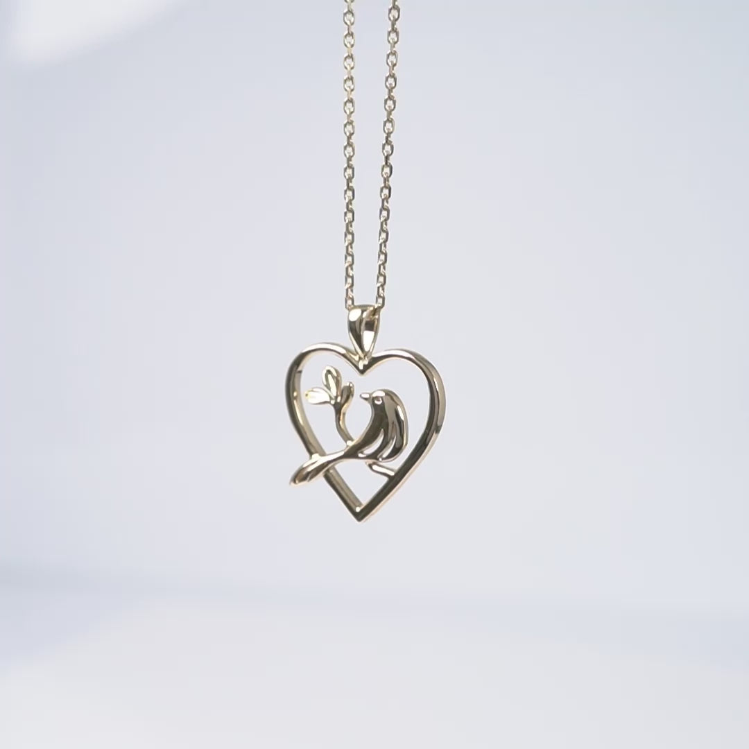 yellow gold bird in heart necklace