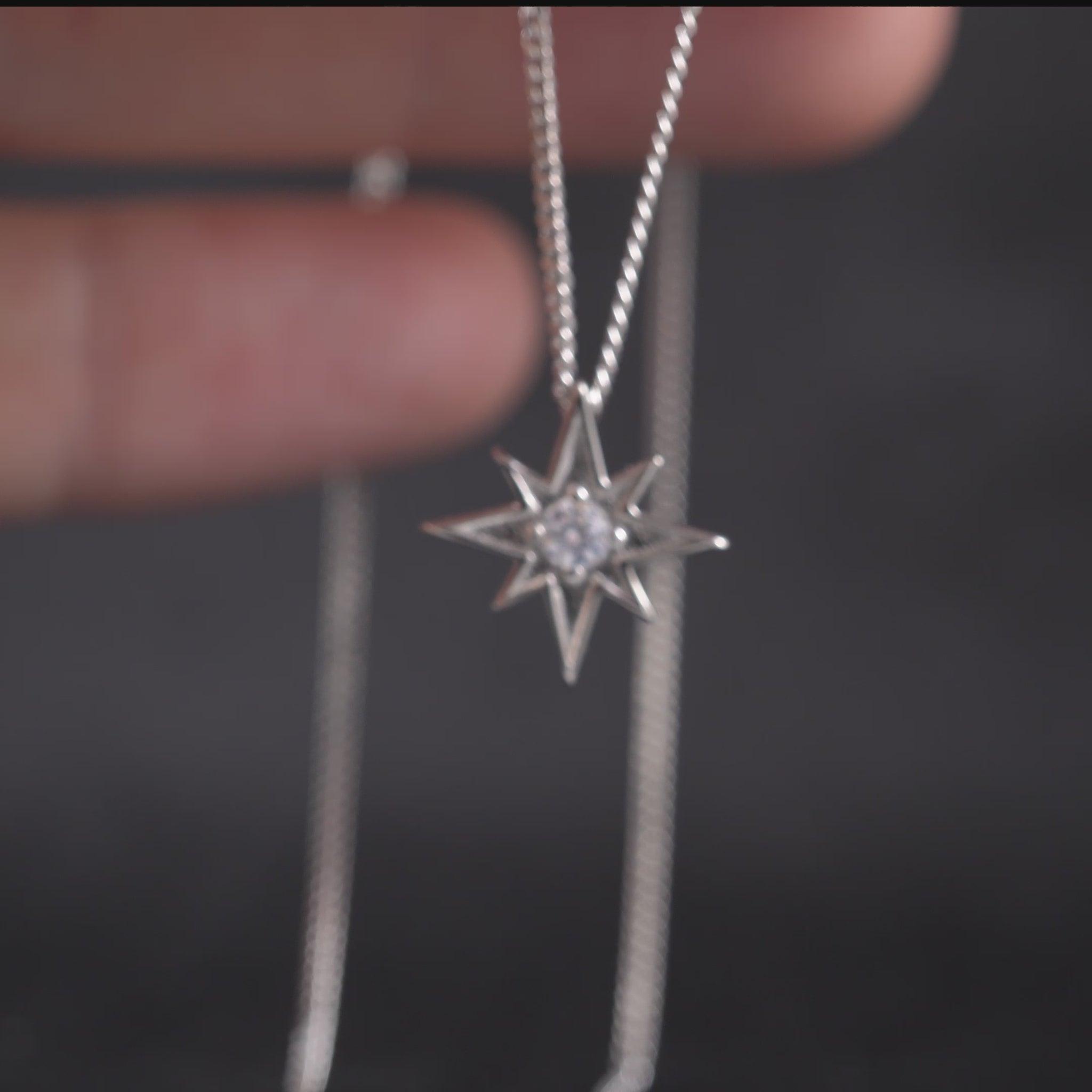 Video thumbnail showing silver North Star necklace close-up