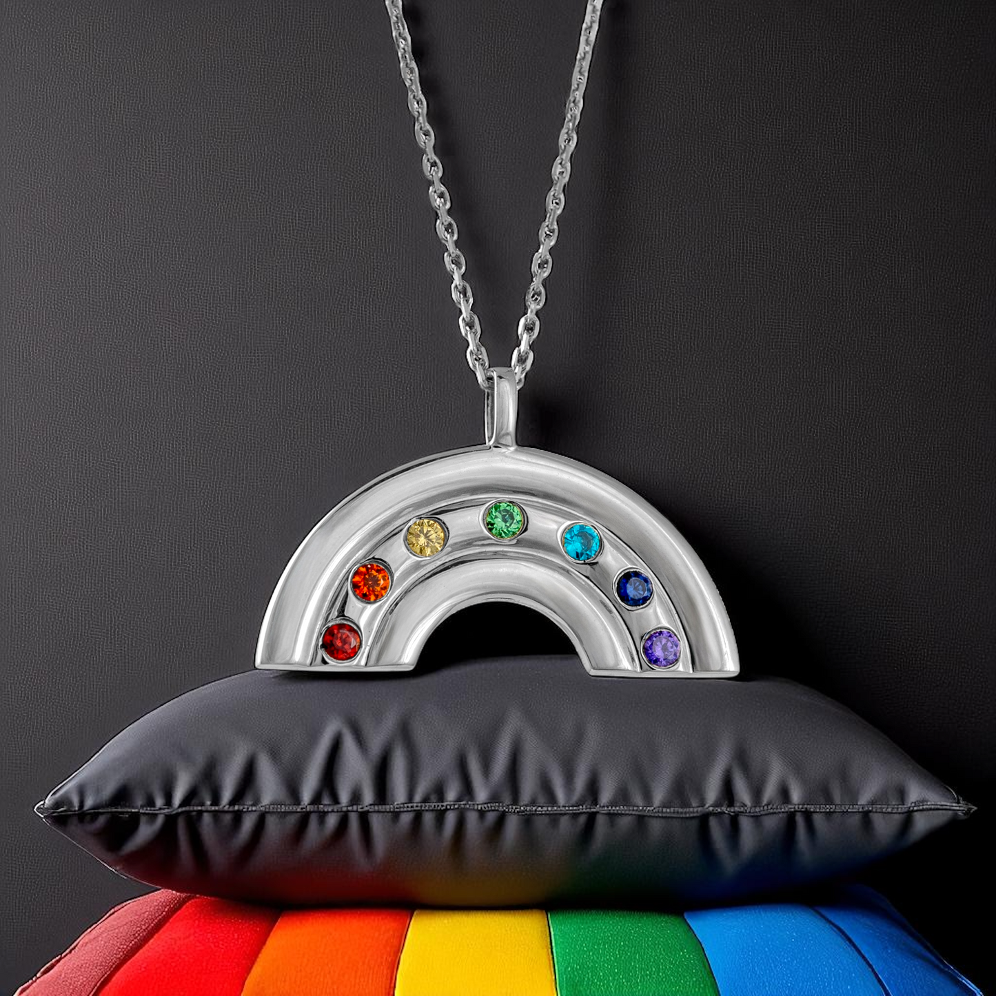 Silver rainbow pendant necklace displayed on rainbows colours display