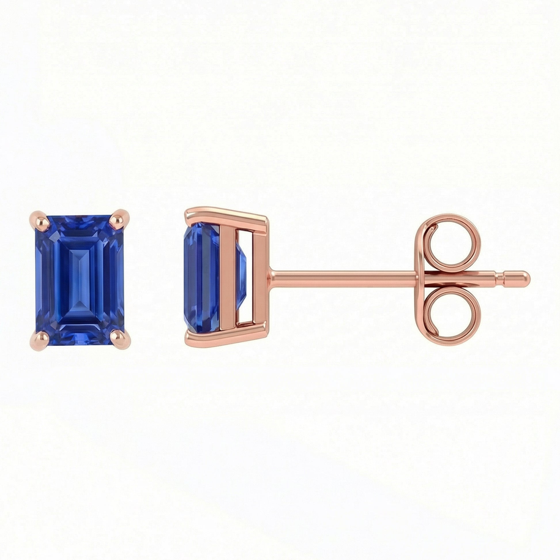 A pair of rose gold stud earrings featuring rectangular emerald-cut blue sapphires, shown from the front and side profile on a clean white background.