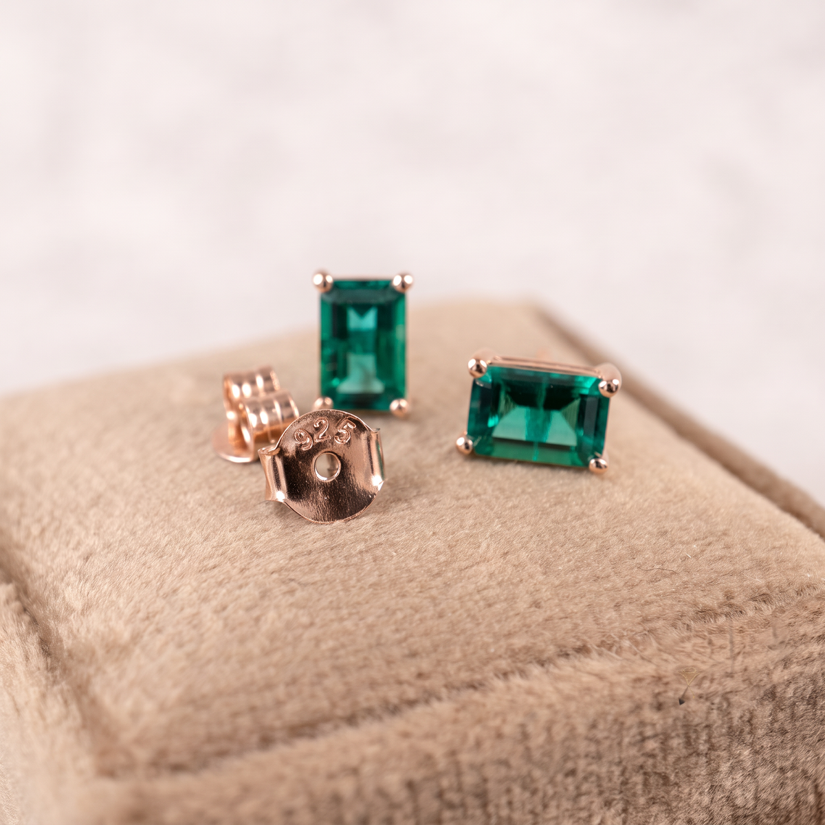 Rose gold emerald stud earrings showing 4 x 6mm rectangle stones and butterfly backs