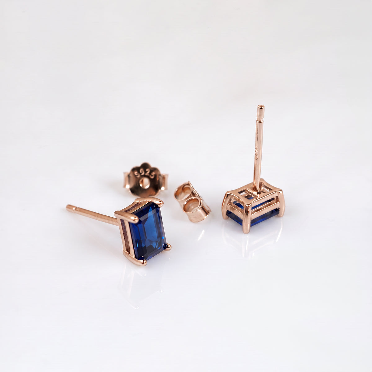 Rose gold-plated sapphire stud earrings showing posts and butterfly backs