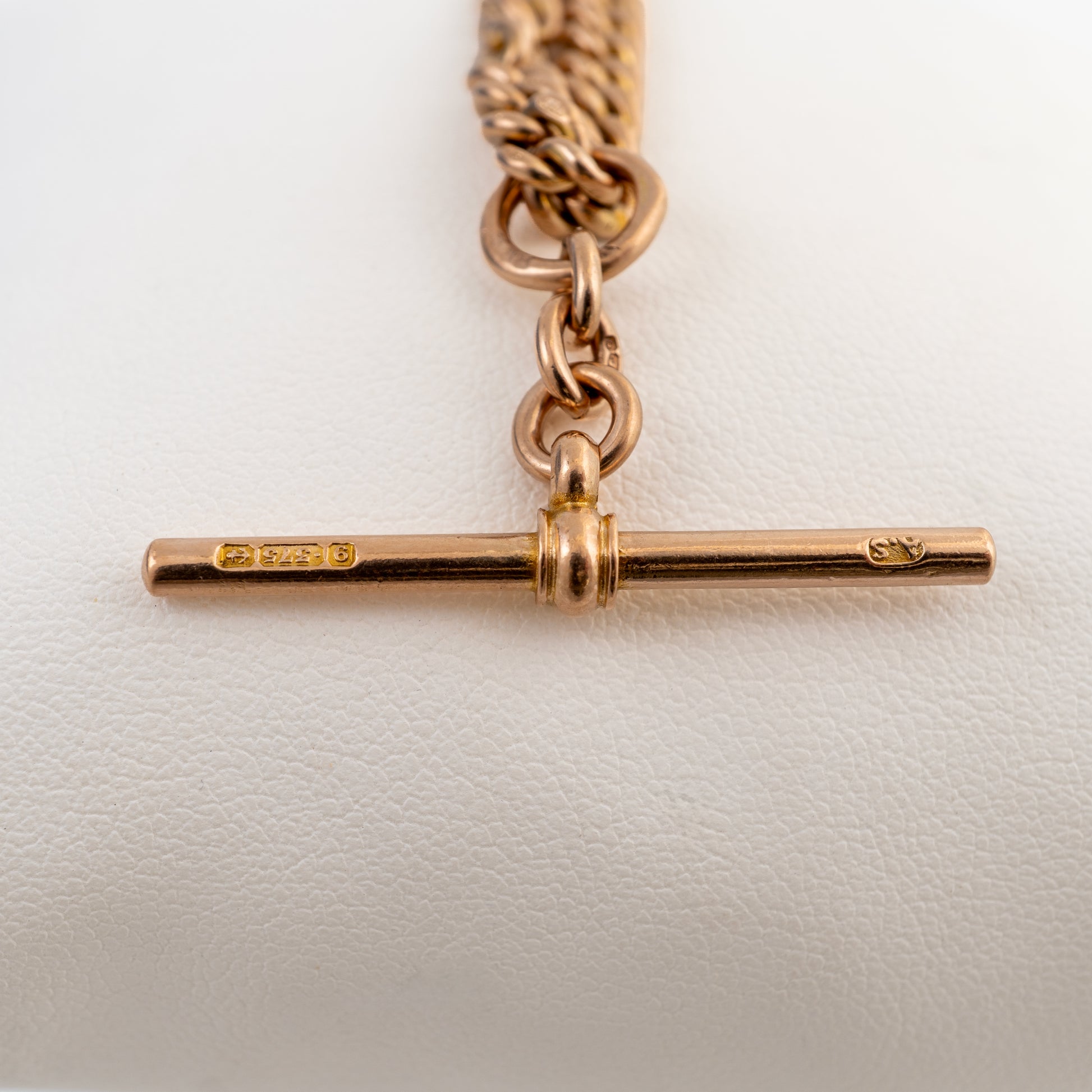 Close-up of the original hallmarked T-bar on an antique Double Albert watch chain showing 375 and A.S. maker's marks