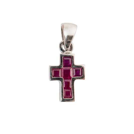A white gold cross pendant featuring a central cross design set with deep pinkish-red square gemstones, isolated on a white background.