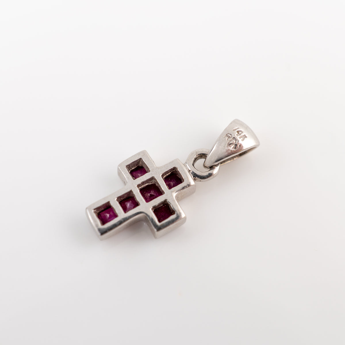 white gold cross pendant reverse side showing hallmarks on bail on a white background
