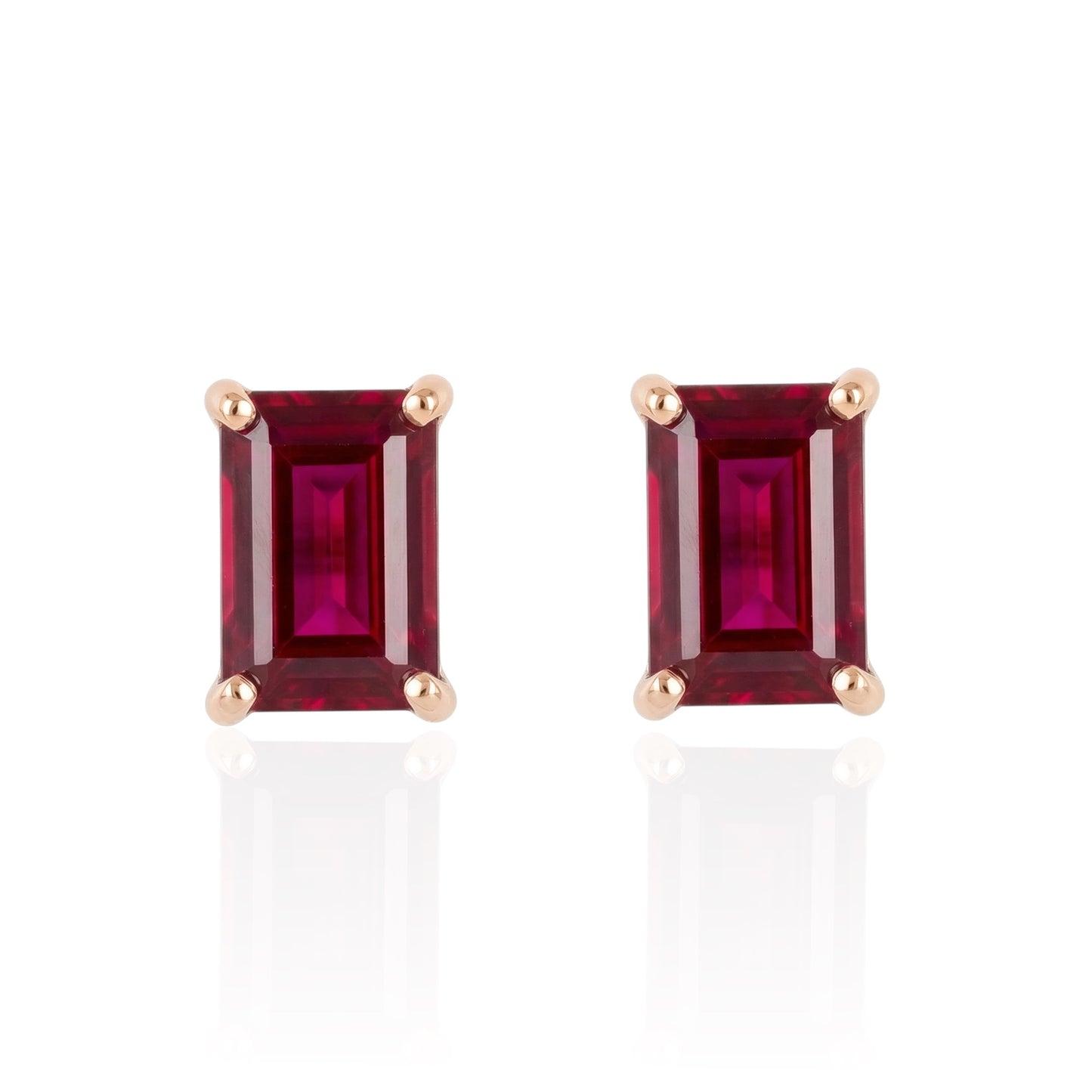 Pair of rectangular ruby stud earrings set in rose gold plated sterling silver front on white background