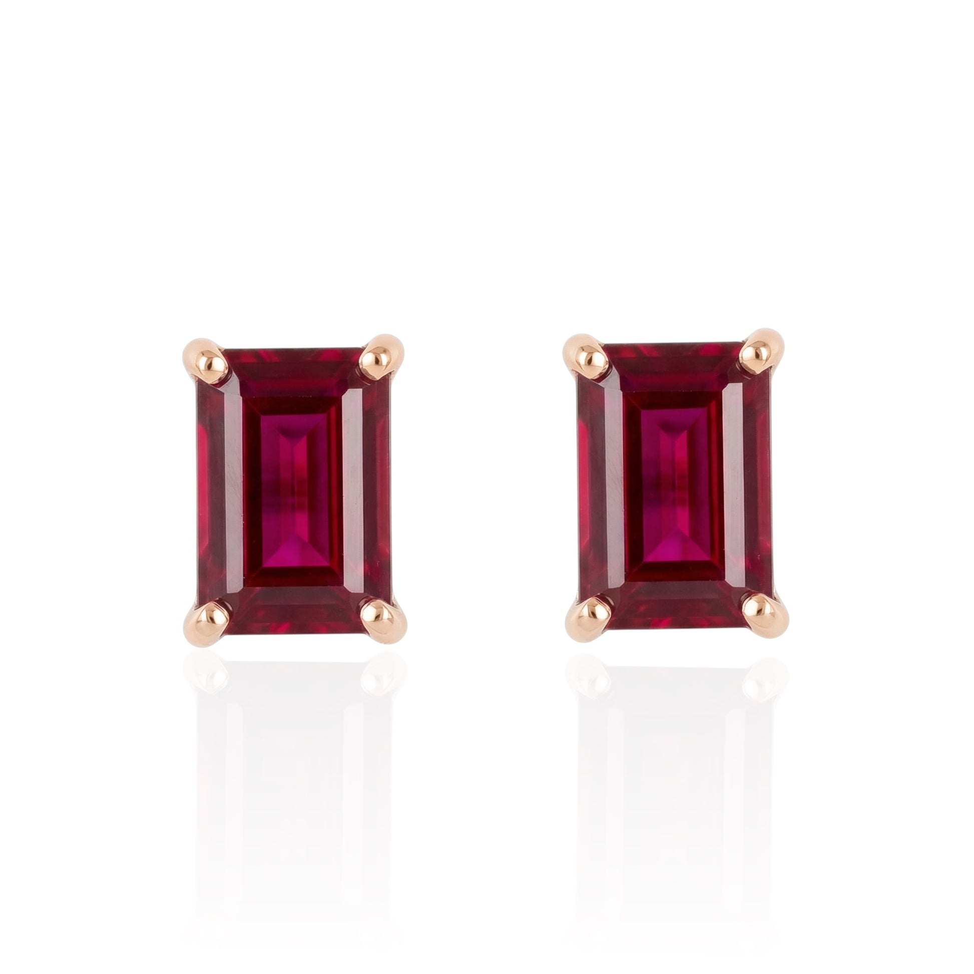 Pair of rectangular ruby stud earrings set in rose gold plated sterling silver front on white background